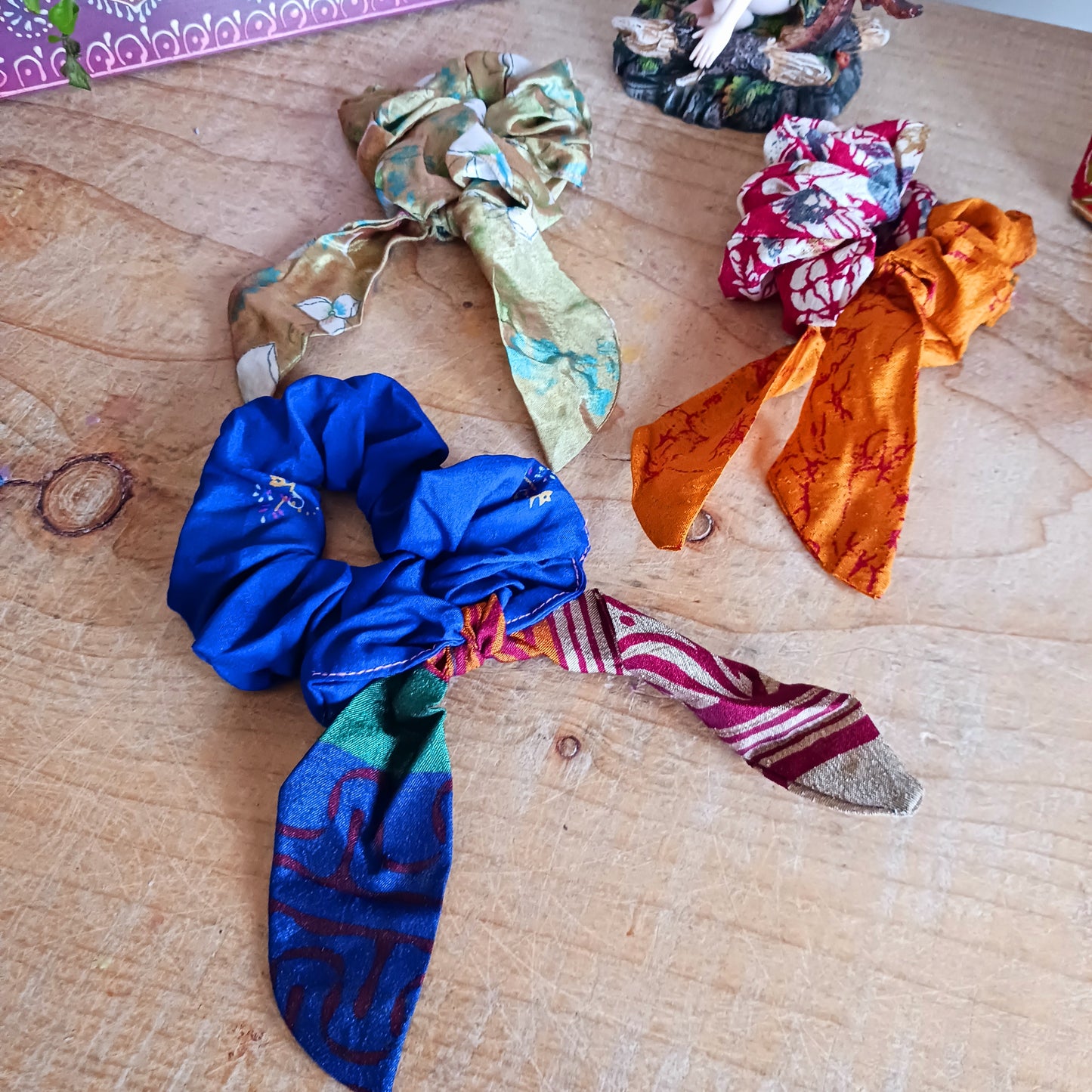 A silky sari material scrunchie styled with a trailing bow feature.  Glamorous sustainable fashion, these beautiful hair accessories come in assorted patterns and colours.