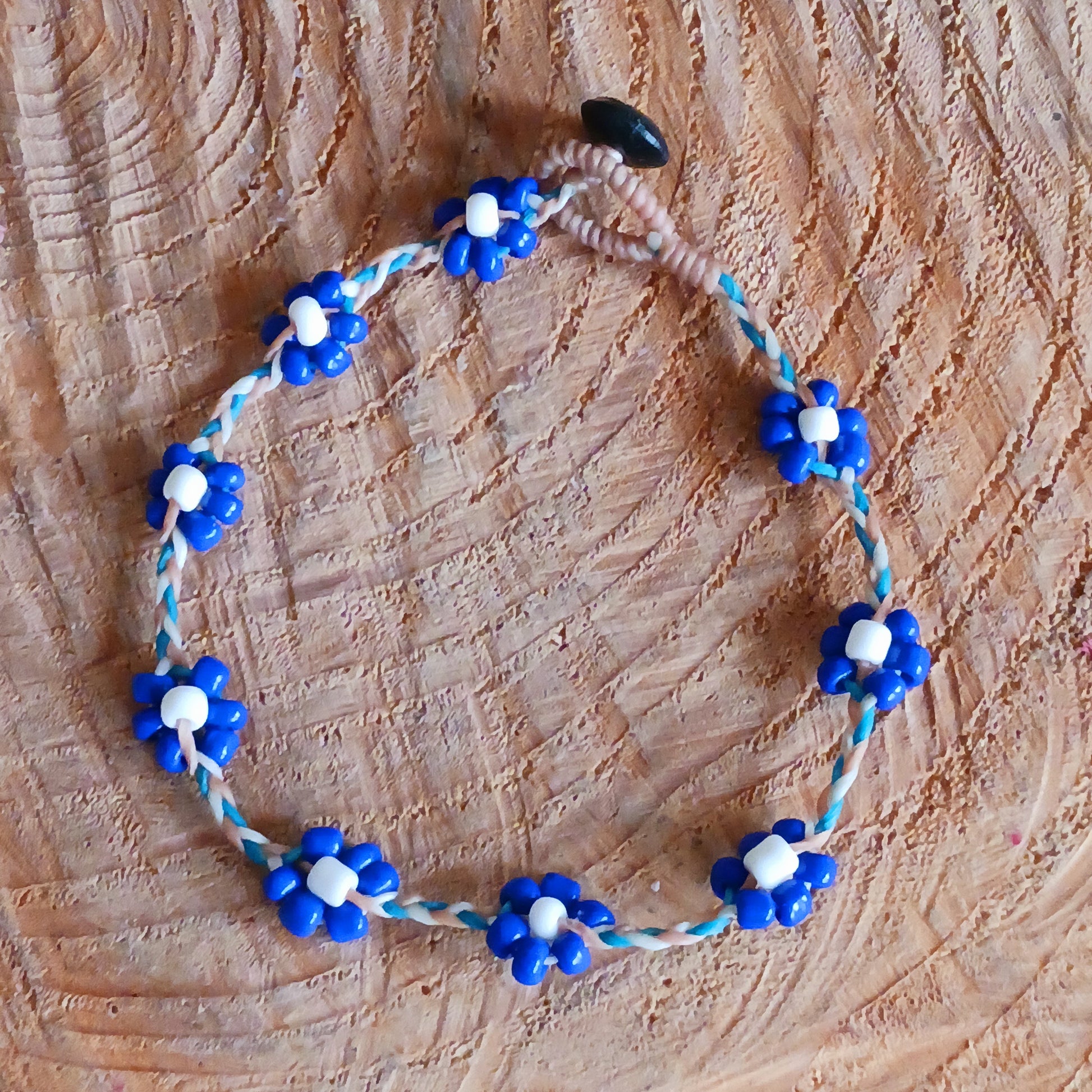 These pretty daisy anklets are made from a collection of beads and and plaited string. They each have a secure fastening and are a great addition to any summer wardrobe.