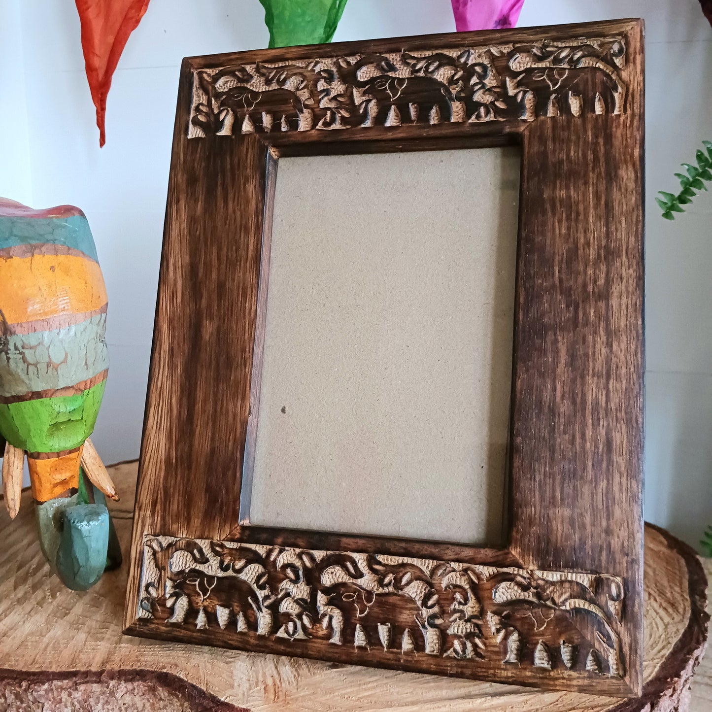 This free-standing mango wood photo frame has a wonderful carved elephant design along top and bottom. The frame will fit 4 x 6" photos (10 x 15cm). Ideal as an eco-friendly gift, or to frame your own happy memories.