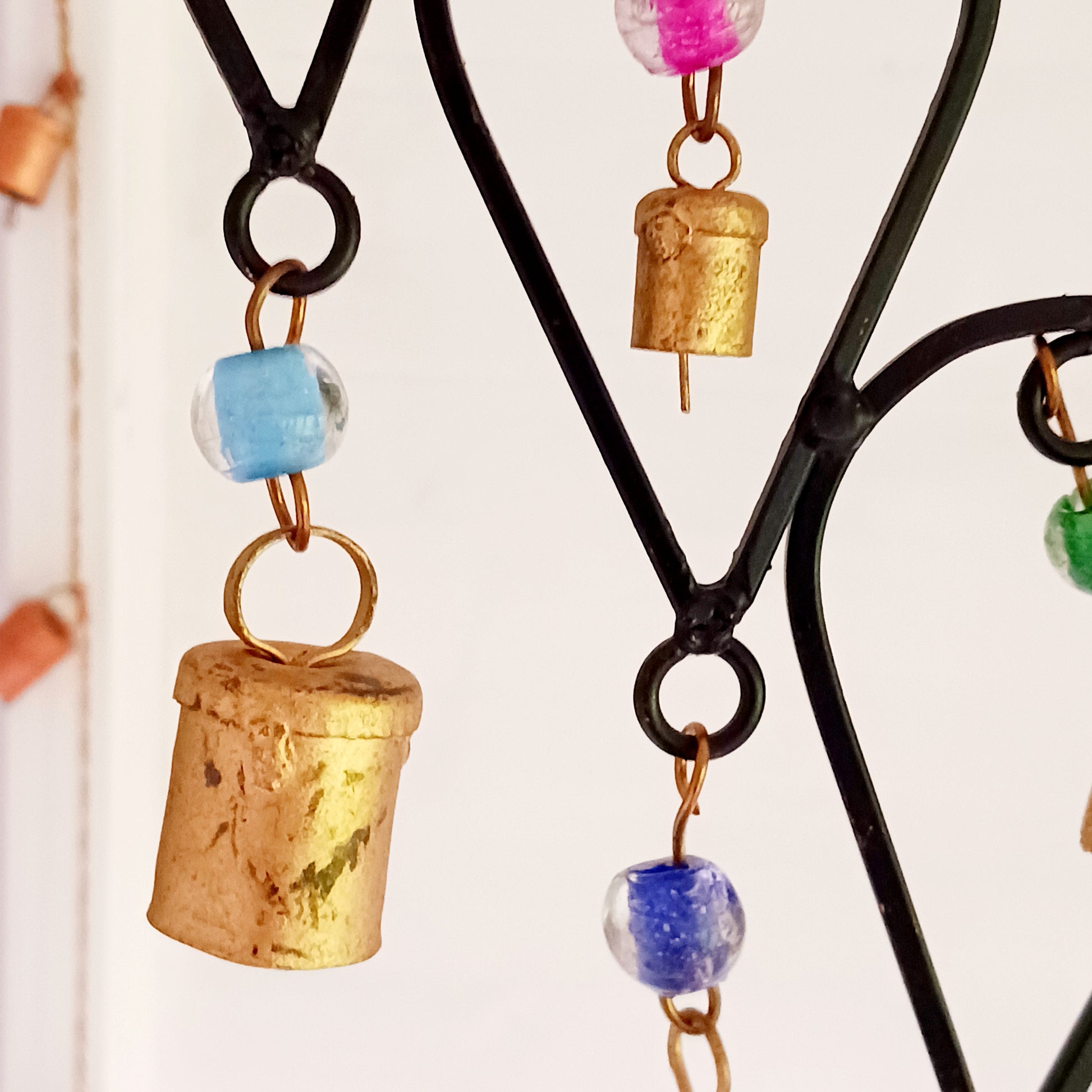 This beautiful windchime has been handmade in Northern India from recycled iron, utilising traditional iron-working skills. At the centre features an elephant image depicted with an upturned trunk, this is widely considered a symbol of good luck. The windchime is also decorated with Indian bells and colourful glass beads. The bells make a lovely, musical sound in a gentle breeze.