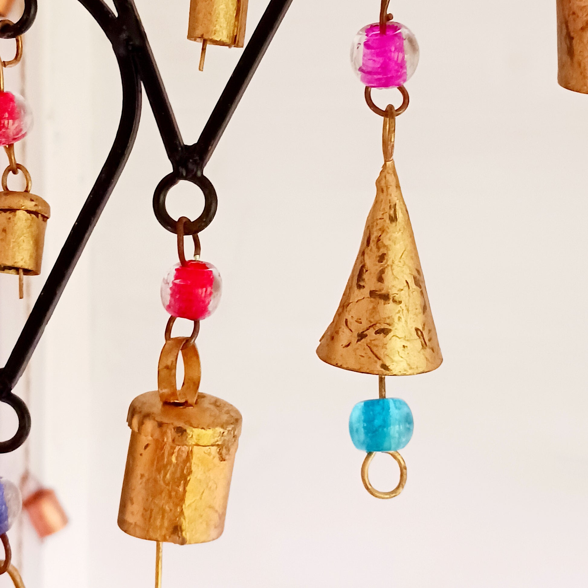 This beautiful windchime has been handmade in Northern India from recycled iron, utilising traditional iron-working skills. At the centre features an elephant image depicted with an upturned trunk, this is widely considered a symbol of good luck. The windchime is also decorated with Indian bells and colourful glass beads. The bells make a lovely, musical sound in a gentle breeze.