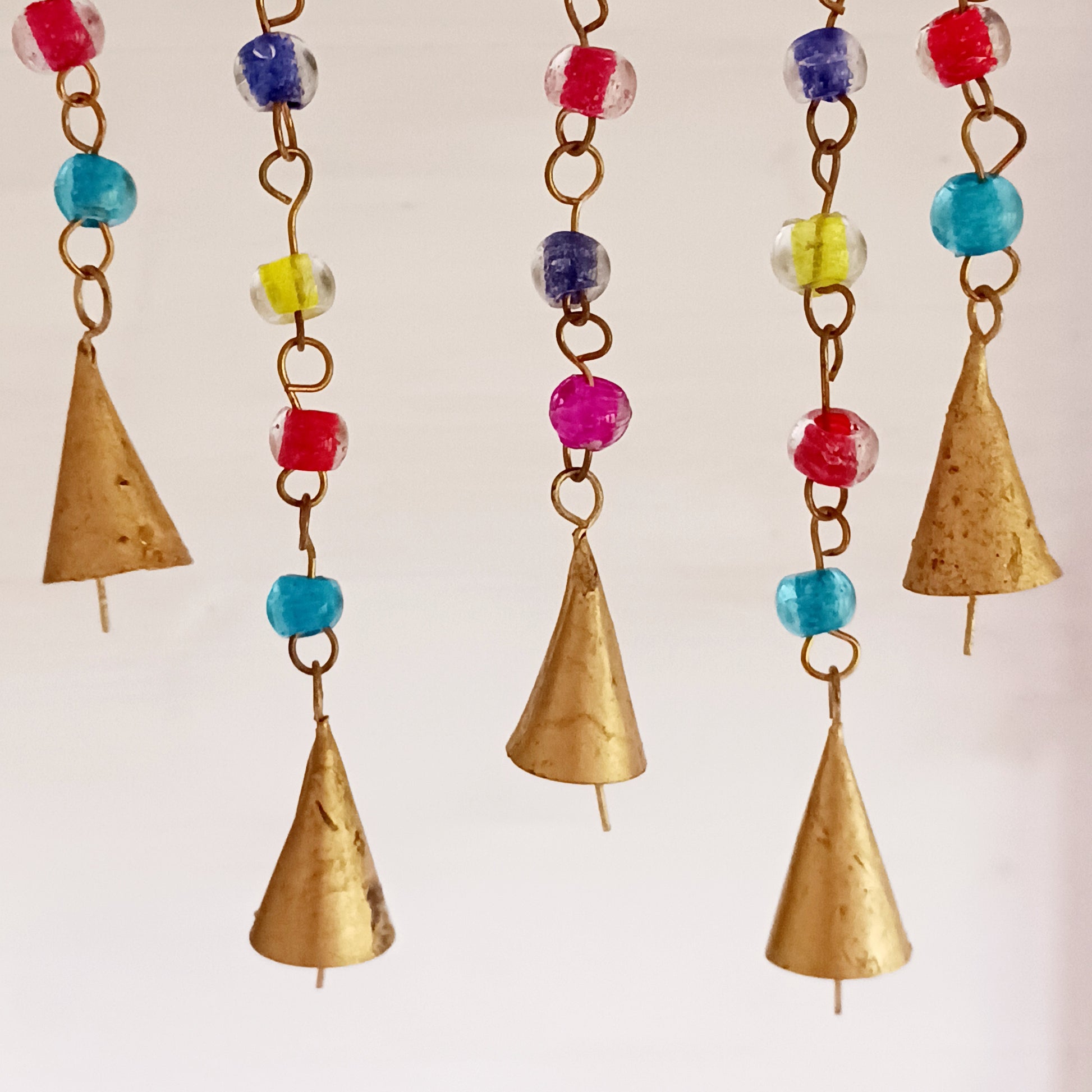 This pretty Butterfly windchime is decorated with vibrant mixed beads and Indian bells. Handmade from recycled iron, the bells make a lovely light tinking sound in a gentle breeze. Ideal for both inside the home or in your garden.