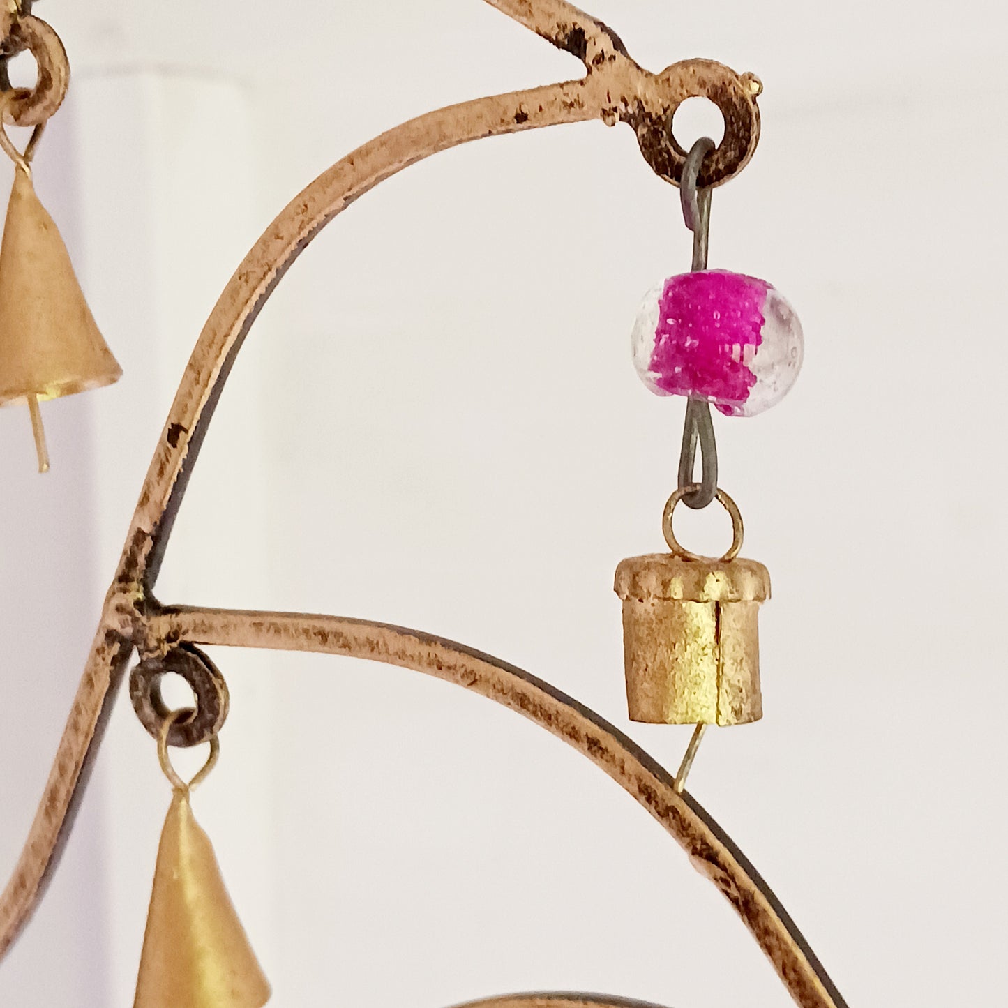 This unusual windchime has been handcrafted from recycled iron in the shape of a Lotus flower. There are 18 hangings, each with an Indian bell at the bottom. The recycled metal gives the windchime a wonderful rustic look, and the Indian bells make a lovely sound in a gentle breeze.