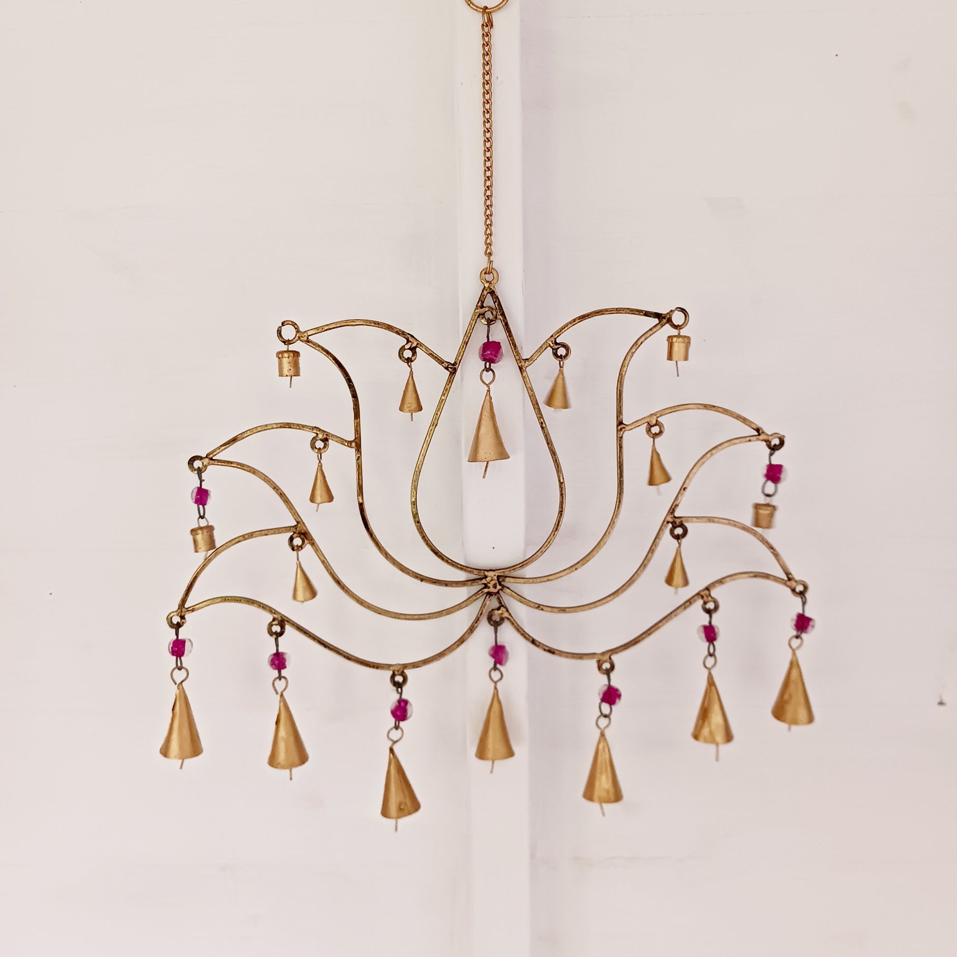 This unusual windchime has been handcrafted from recycled iron in the shape of a Lotus flower. There are 18 hangings, each with an Indian bell at the bottom. The recycled metal gives the windchime a wonderful rustic look, and the Indian bells make a lovely sound in a gentle breeze.