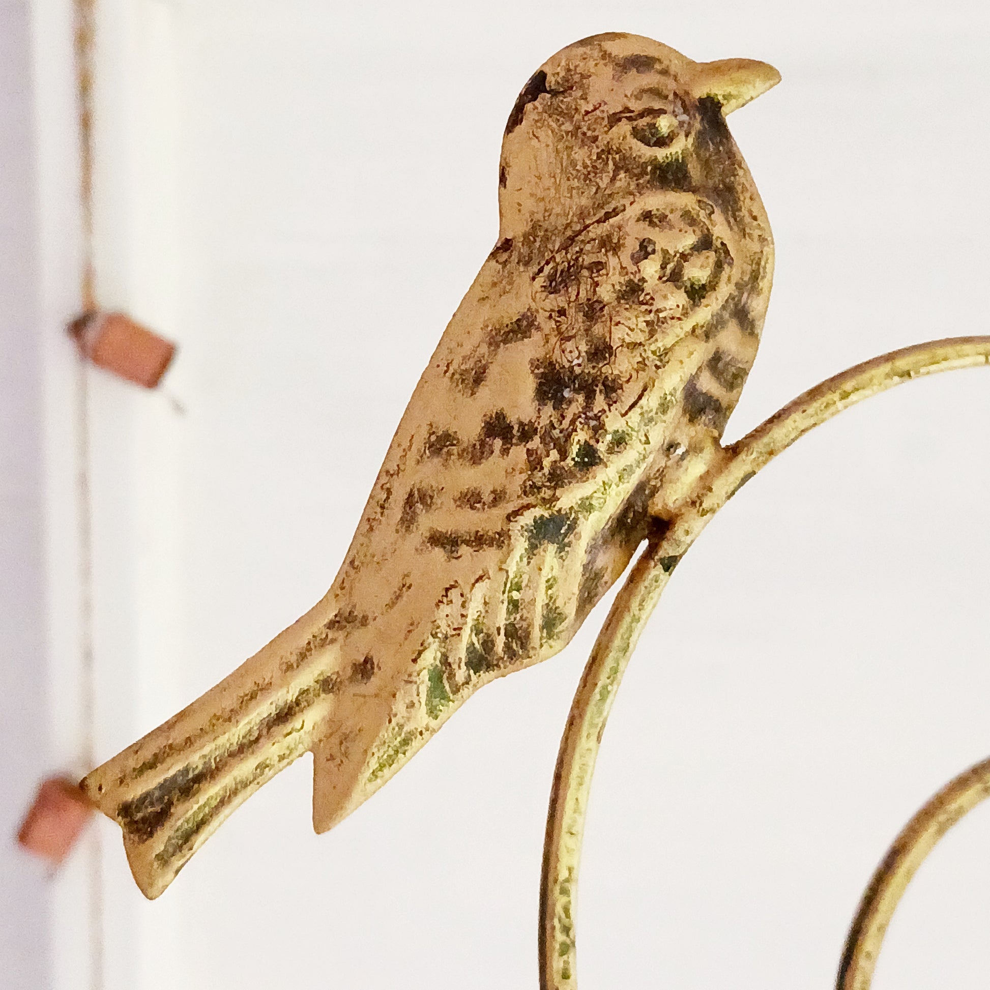 This lovely windchime is features a large metal heart that encloses a smaller heart, that in turn, holds an Indian decorative bell. Perched on the top of the windchime sit a pair of feather detailed birds. The hanging windchime decoration has a mounting chain and is completed by 7 Indian bells on the bottom edge; the largest bell in the centre.