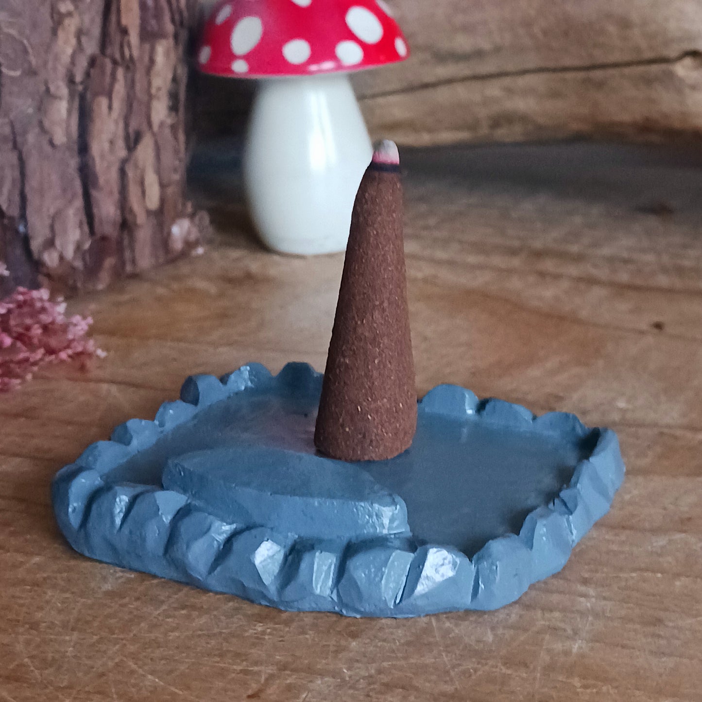 This adorable and detailed incense cone burner is shaped like a little fairy house called Woody Lodge. Designed by Lisa Parker, you place an incense cone inside the Woody Lodge and watch as smoke rises from the chimney. The house comes in a little gift box making it the perfect gift for fairy and incense lovers!