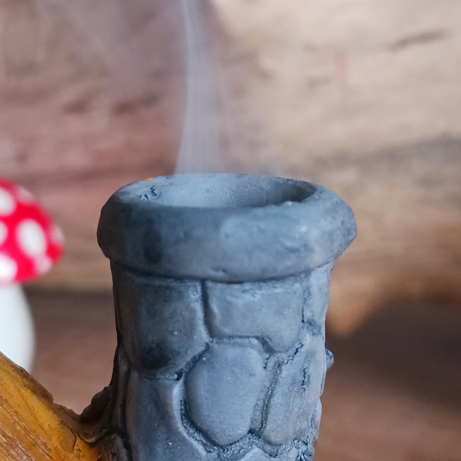 This adorable and detailed incense cone burner is shaped like a little fairy house called Buttercup Cottage. 
 Designed by Lisa Parker, you place an incense cone inside the cottage and watch as smoke rises from the chimney. The house comes in a little gift box making it the perfect gift for fairy and incense lovers!