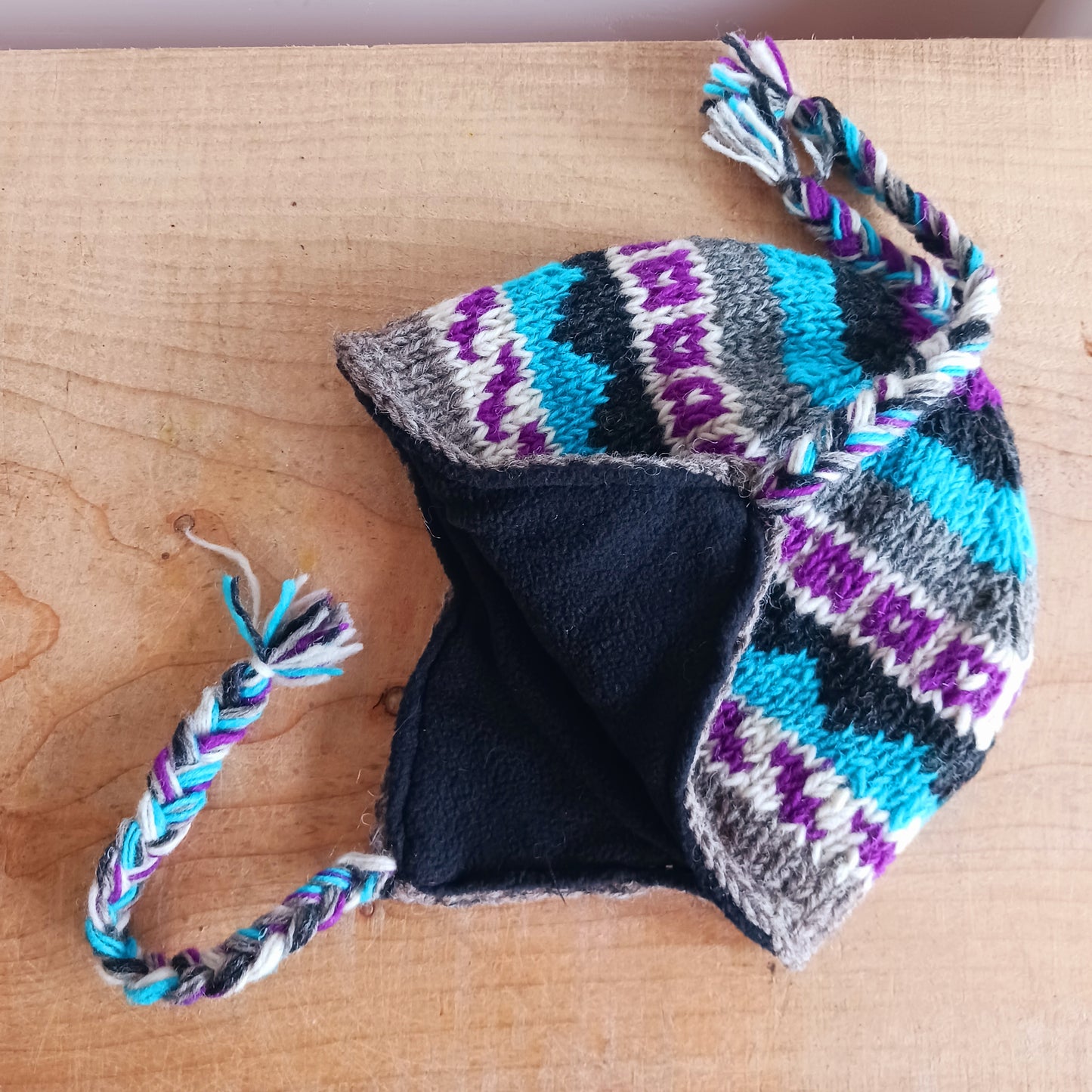 Chunky wool earflap hats hand made in Nepal with fleece lining for extra warmth and comfort, this handmade hat is awesomely warm.