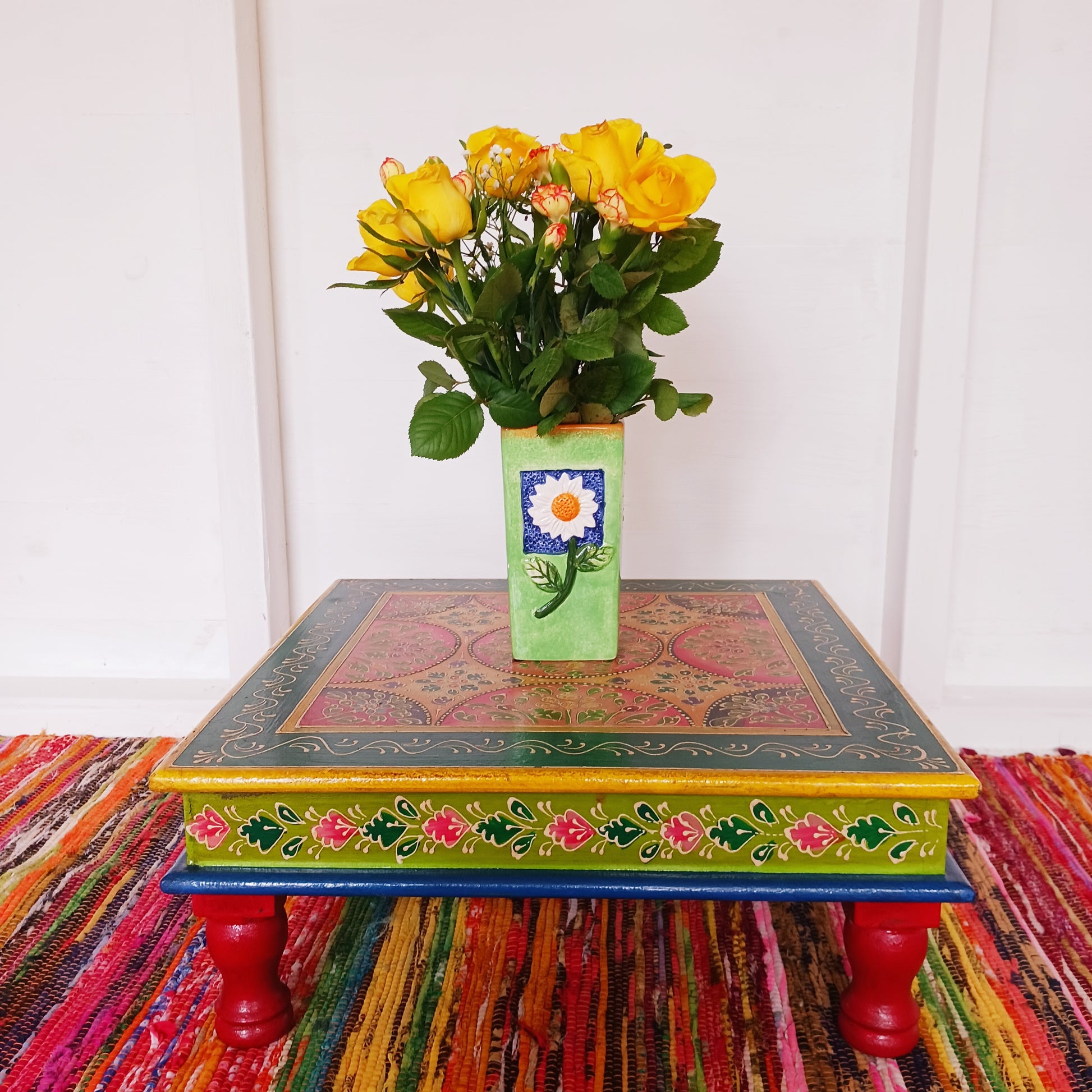 Bring a touch of Indian vibrance to your home with this stunning hand-painted pink and lime bajot table.  Hand crafted from solid wood and decorated with eye-catching Indian motifs, this lovely piece of furniture makes a charming coffee table or unique accent piece.