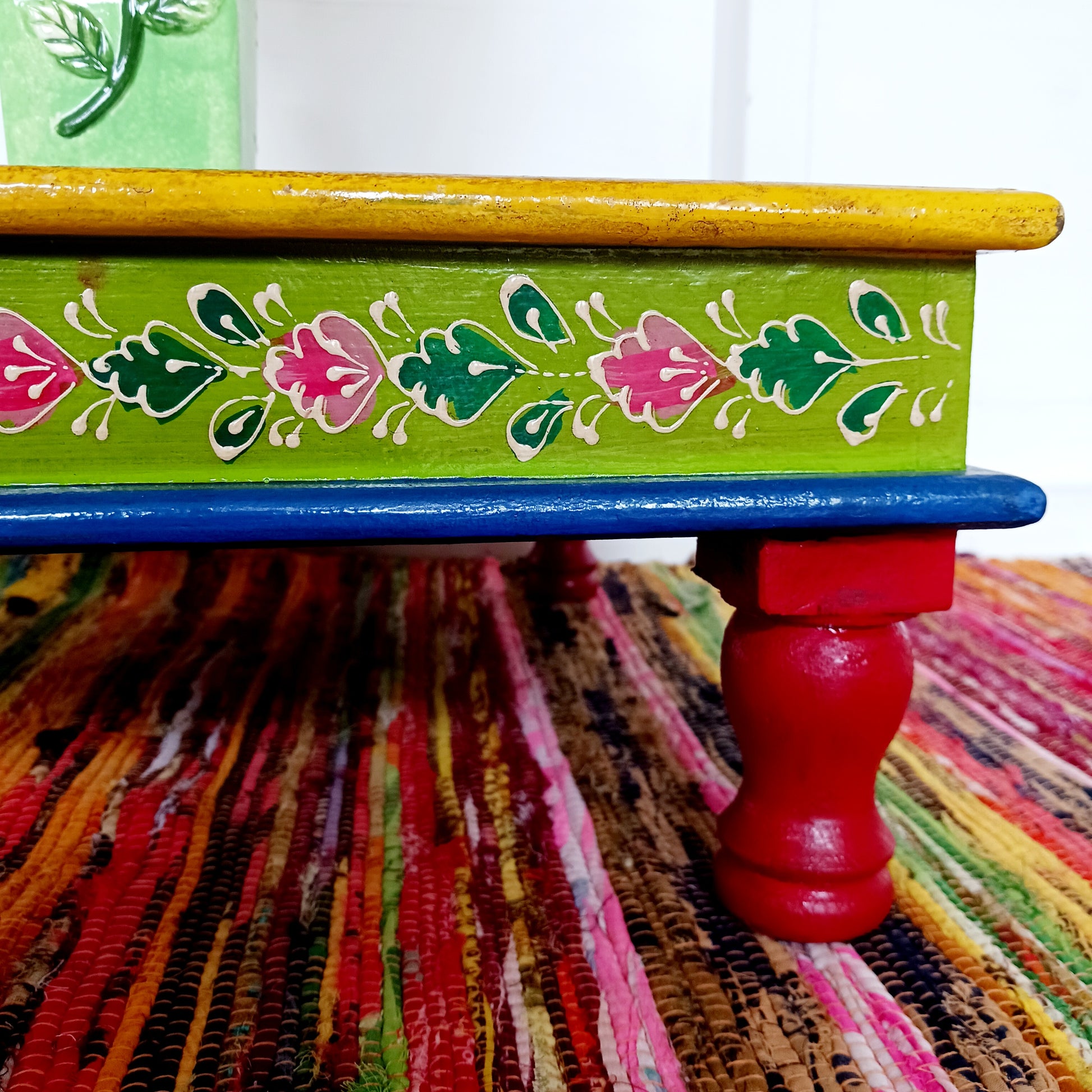 Bring a touch of Indian vibrance to your home with this stunning hand-painted pink and lime bajot table.  Hand crafted from solid wood and decorated with eye-catching Indian motifs, this lovely piece of furniture makes a charming coffee table or unique accent piece.