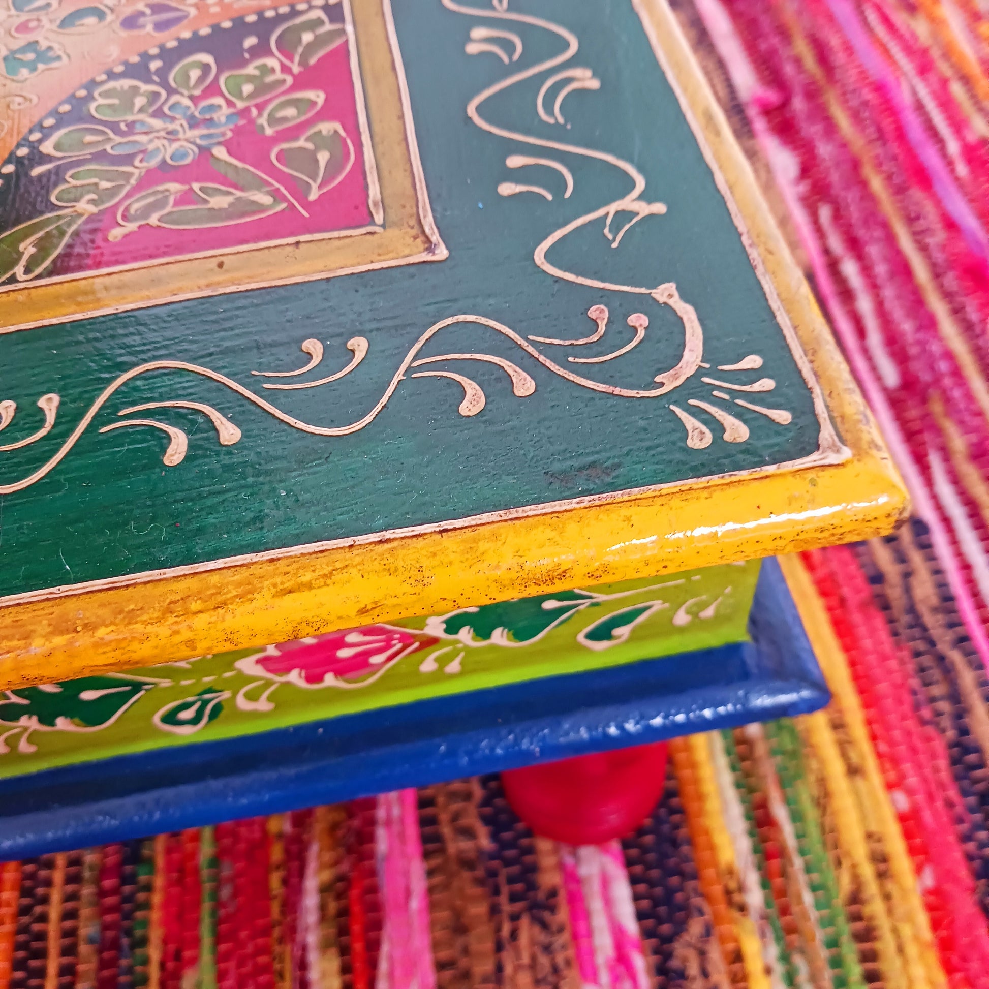 Bring a touch of Indian vibrance to your home with this stunning hand-painted pink and lime bajot table.  Hand crafted from solid wood and decorated with eye-catching Indian motifs, this lovely piece of furniture makes a charming coffee table or unique accent piece.