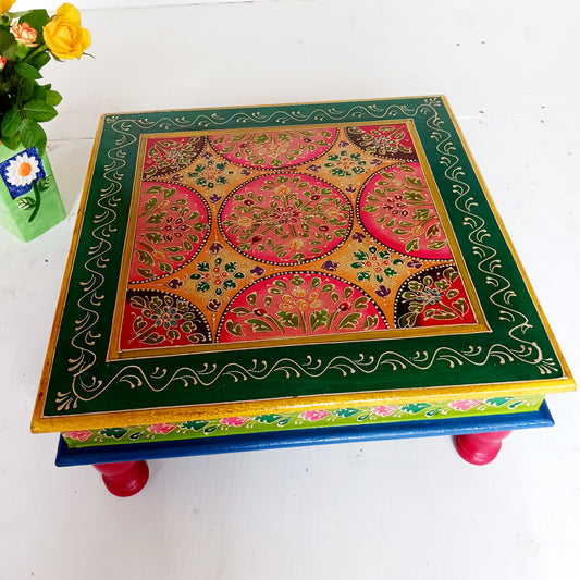Bring a touch of Indian vibrance to your home with this stunning hand-painted pink and lime bajot table.  Hand crafted from solid wood and decorated with eye-catching Indian motifs, this lovely piece of furniture makes a charming coffee table or unique accent piece.