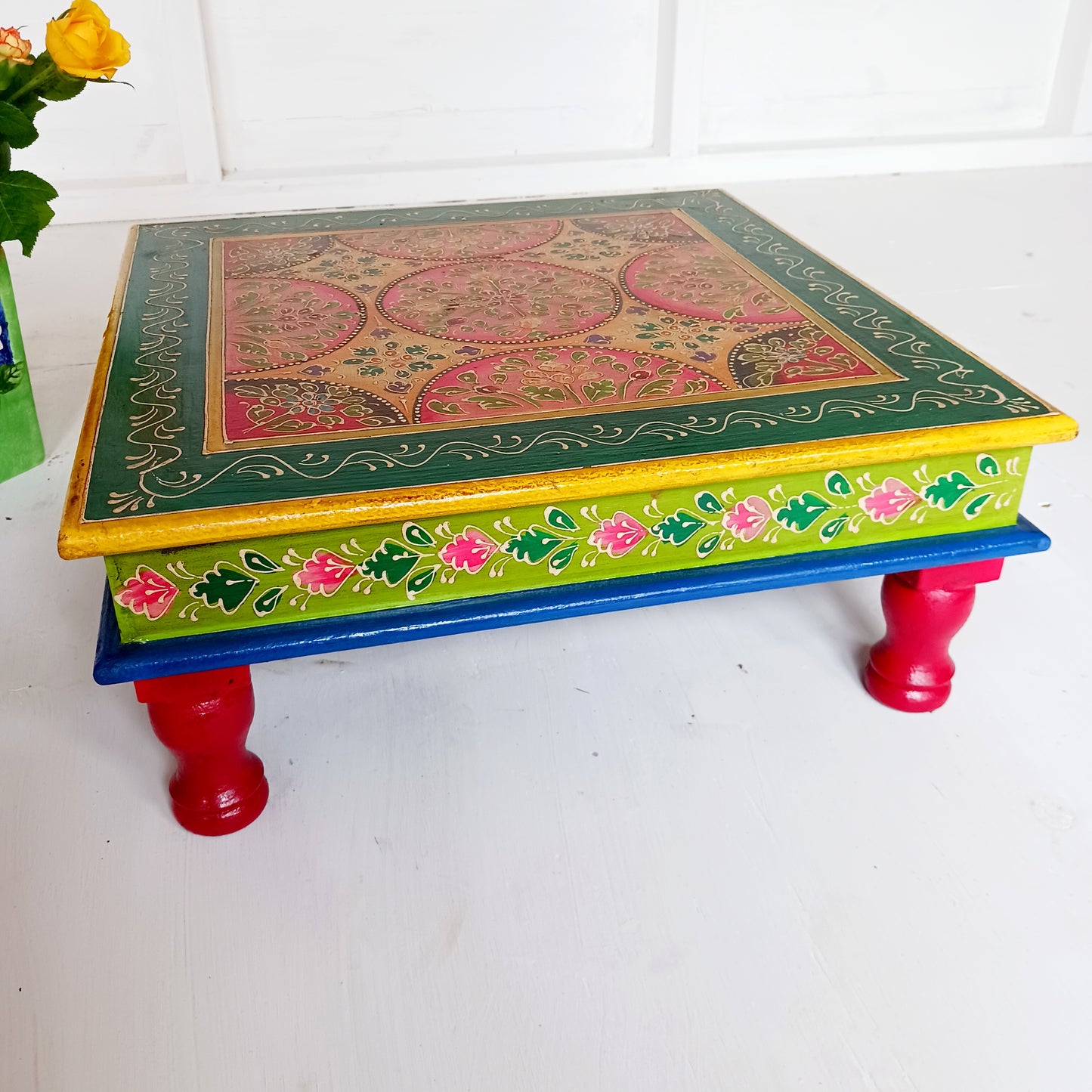 Bring a touch of Indian vibrance to your home with this stunning hand-painted pink and lime bajot table.  Hand crafted from solid wood and decorated with eye-catching Indian motifs, this lovely piece of furniture makes a charming coffee table or unique accent piece.