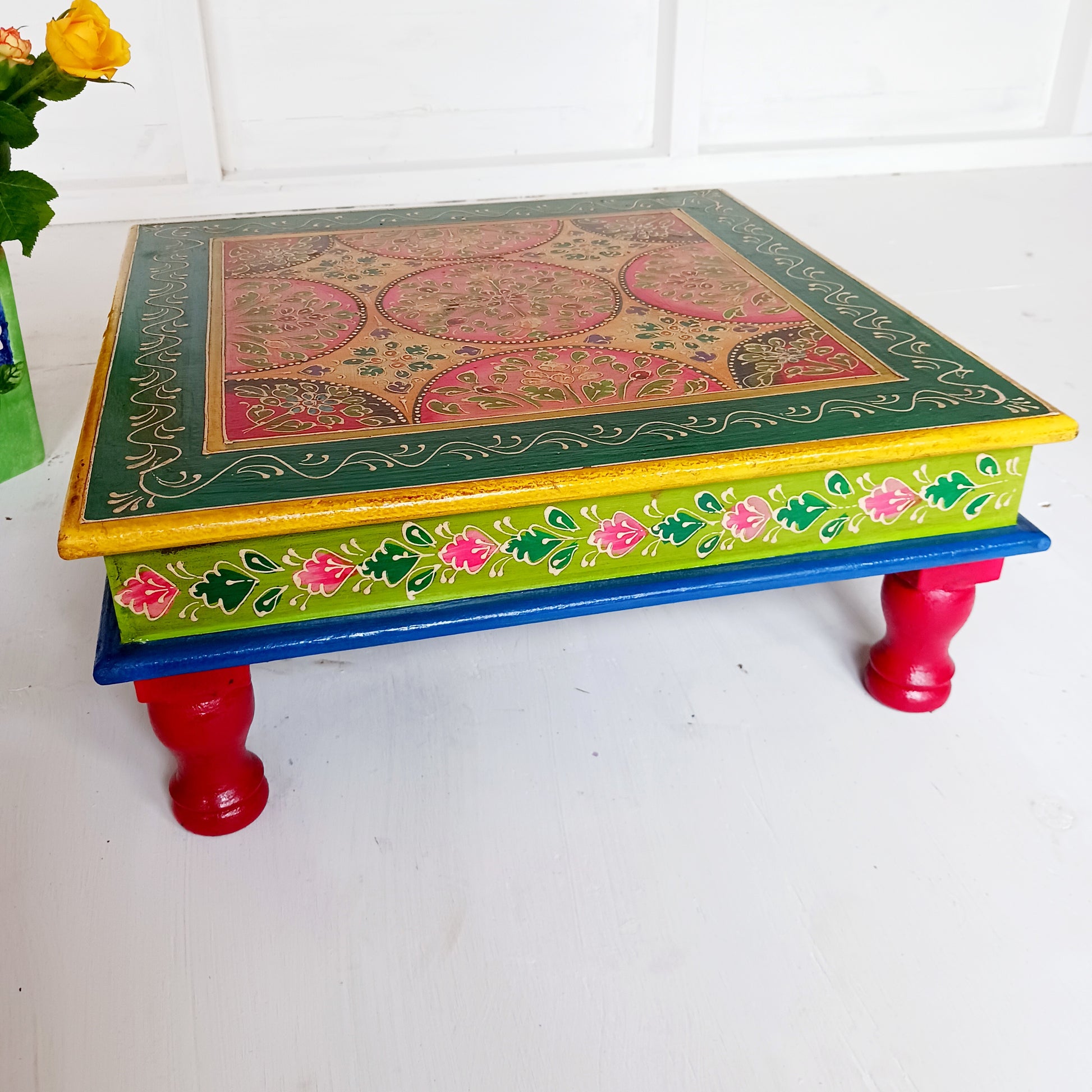 Bring a touch of Indian vibrance to your home with this stunning hand-painted pink and lime bajot table.  Hand crafted from solid wood and decorated with eye-catching Indian motifs, this lovely piece of furniture makes a charming coffee table or unique accent piece.