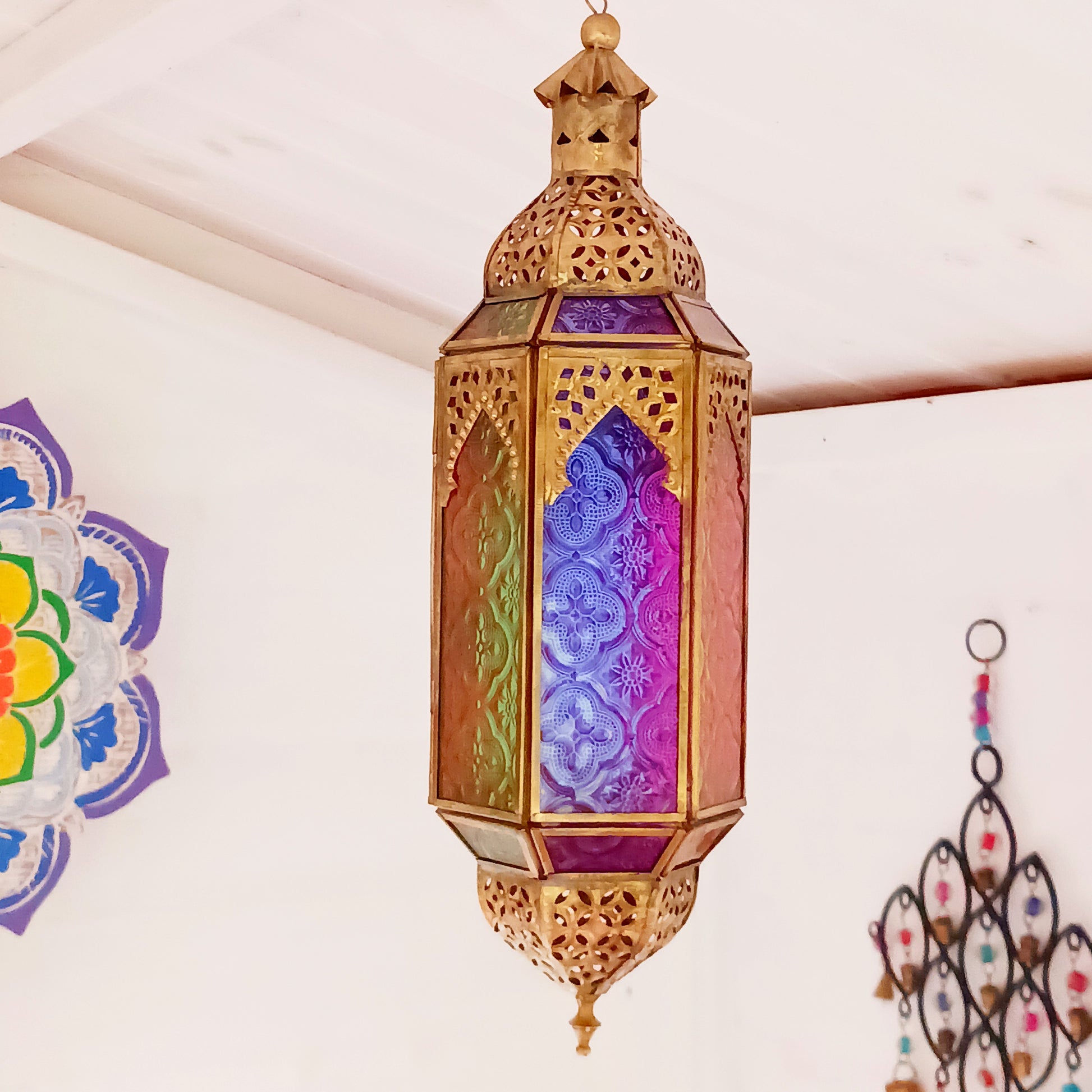 These stunning hanging tealight lanterns feature a rich combination of embossed coloured glass against intricate metal crafted design. Add a warming touch to evenings and enjoy the soothing ambience of natural light against lustrous colour. Super for entertaining inside or out, this gorgeous creation is sure to be a conversation booster!