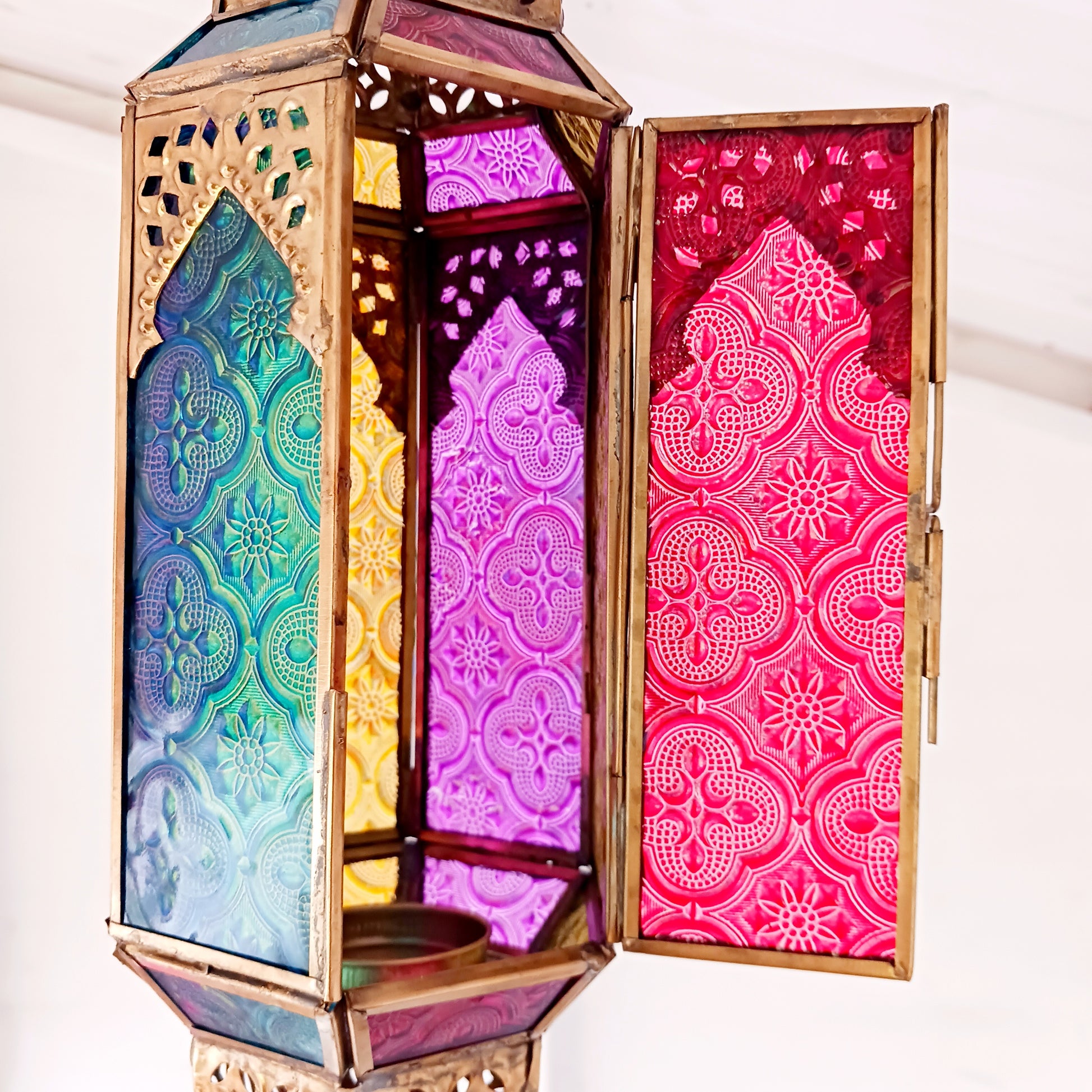 These stunning hanging tealight lanterns feature a rich combination of embossed coloured glass against intricate metal crafted design. Add a warming touch to evenings and enjoy the soothing ambience of natural light against lustrous colour. Super for entertaining inside or out, this gorgeous creation is sure to be a conversation booster!
