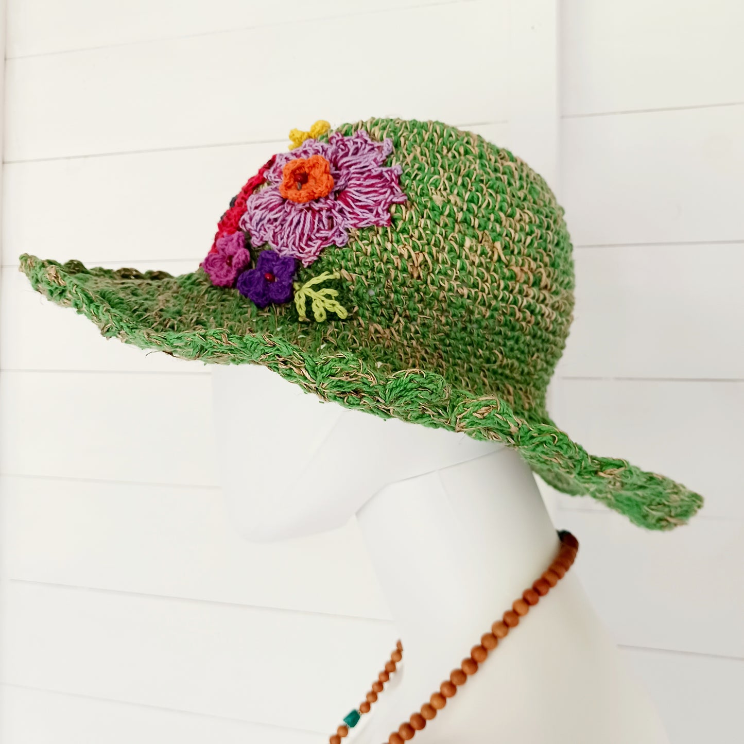 Hand-knitted Hemp & Cotton Boho Festival Hat with Rainbow band. A unique accessory that beautifully embodies the free-spirited essence of Bohemian style. Handcrafted with care, each of these hats is a harmonious blend of hemp and cotton, resulting in a distinctive piece that exudes both fashion and sustainability. They're ideal for music festivals, beach outings, or simply just to brighten up any outfit.
