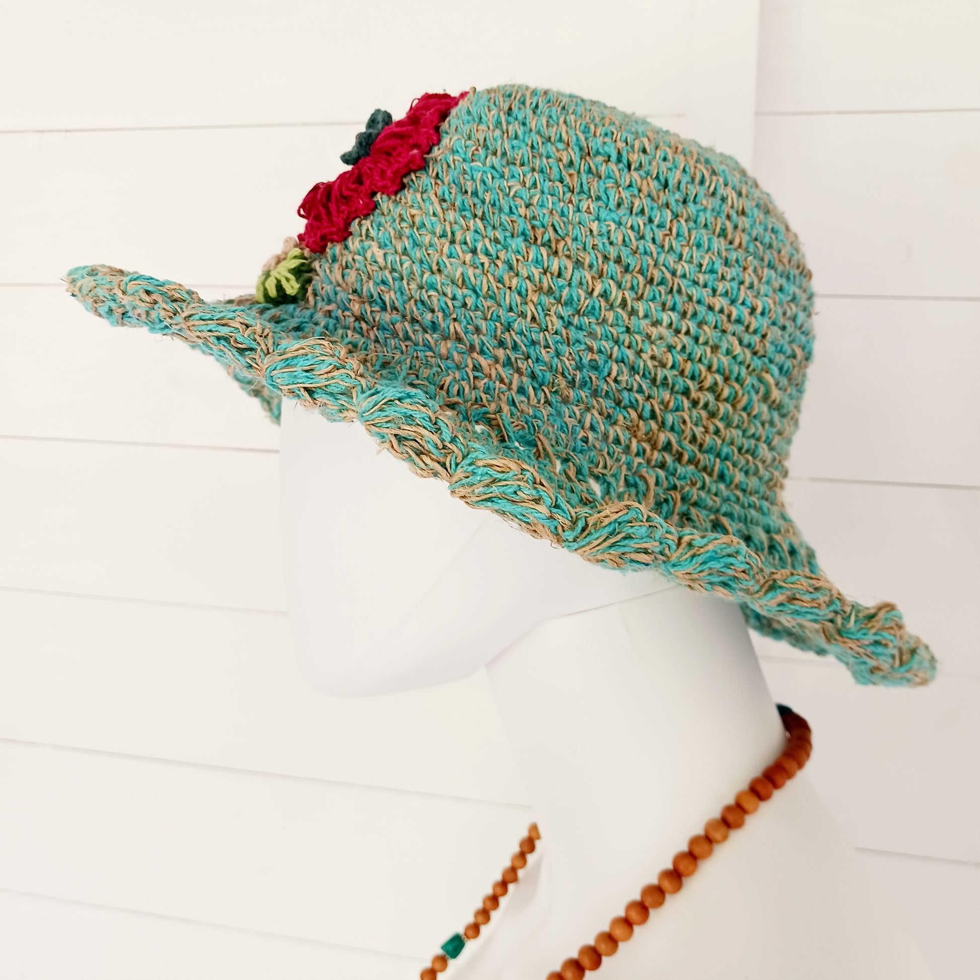 Handmade hemp & cotton boho festival hat with crochet flowers. A unique accessory that beautifully embodies the free-spirited essence of Bohemian style. Handcrafted with care and creativity, each of these hats is a harmonious blend of hemp and cotton, resulting in a distinctive piece that exudes both fashion and sustainability. They're ideal for music festivals, beach outings, or simply just to brighten up any outfit.