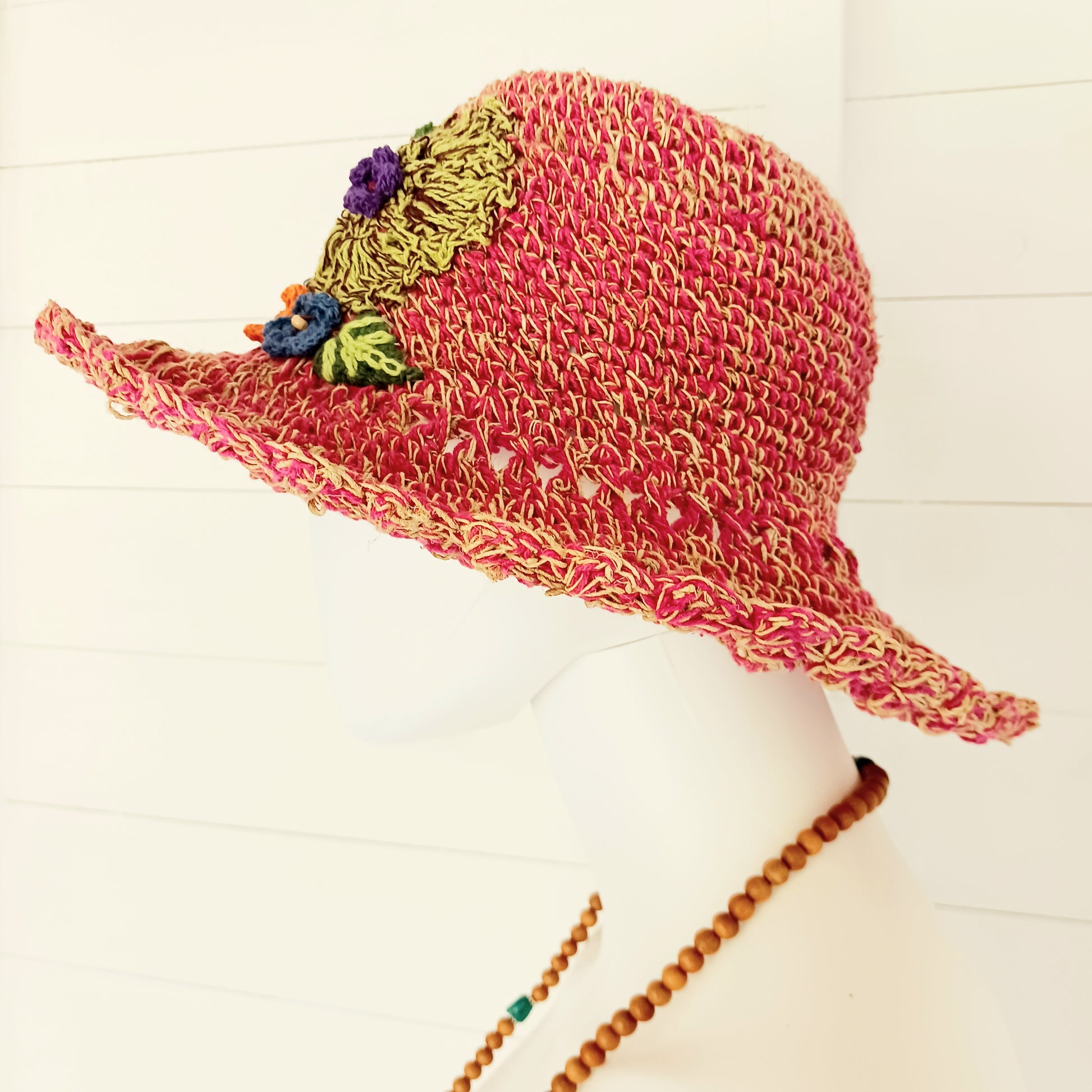 Handmade hemp & cotton boho festival hat with crochet flowers. A unique accessory that beautifully embodies the free-spirited essence of Bohemian style. Handcrafted with care and creativity, each of these hats is a harmonious blend of hemp and cotton, resulting in a distinctive piece that exudes both fashion and sustainability. They're ideal for music festivals, beach outings, or simply just to brighten up any outfit.