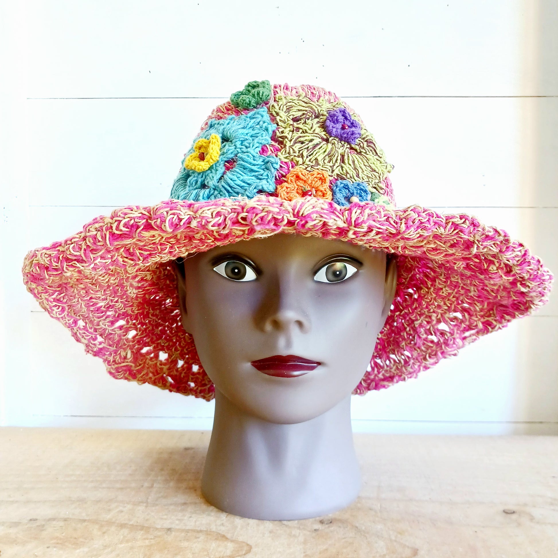 Handmade hemp & cotton boho festival hat with crochet flowers. A unique accessory that beautifully embodies the free-spirited essence of Bohemian style. Handcrafted with care and creativity, each of these hats is a harmonious blend of hemp and cotton, resulting in a distinctive piece that exudes both fashion and sustainability. They're ideal for music festivals, beach outings, or simply just to brighten up any outfit.