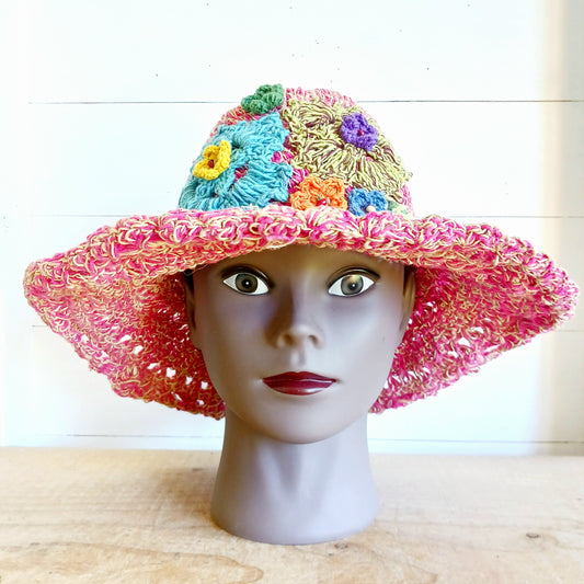 Handmade hemp & cotton boho festival hat with crochet flowers. A unique accessory that beautifully embodies the free-spirited essence of Bohemian style. Handcrafted with care and creativity, each of these hats is a harmonious blend of hemp and cotton, resulting in a distinctive piece that exudes both fashion and sustainability. They're ideal for music festivals, beach outings, or simply just to brighten up any outfit.