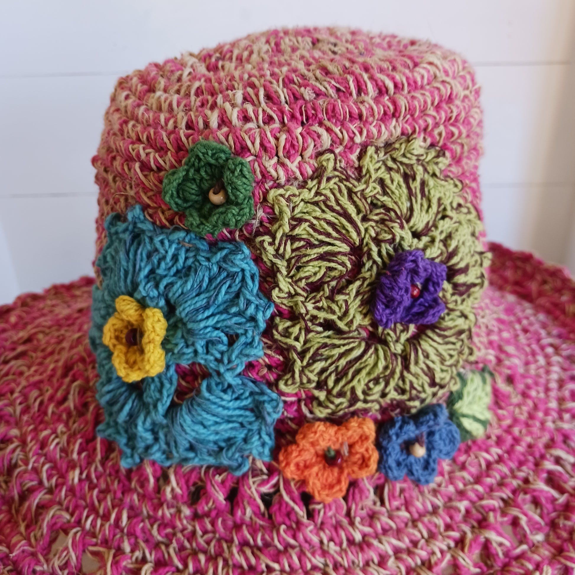 Handmade hemp & cotton boho festival hat with crochet flowers. A unique accessory that beautifully embodies the free-spirited essence of Bohemian style. Handcrafted with care and creativity, each of these hats is a harmonious blend of hemp and cotton, resulting in a distinctive piece that exudes both fashion and sustainability. They're ideal for music festivals, beach outings, or simply just to brighten up any outfit.