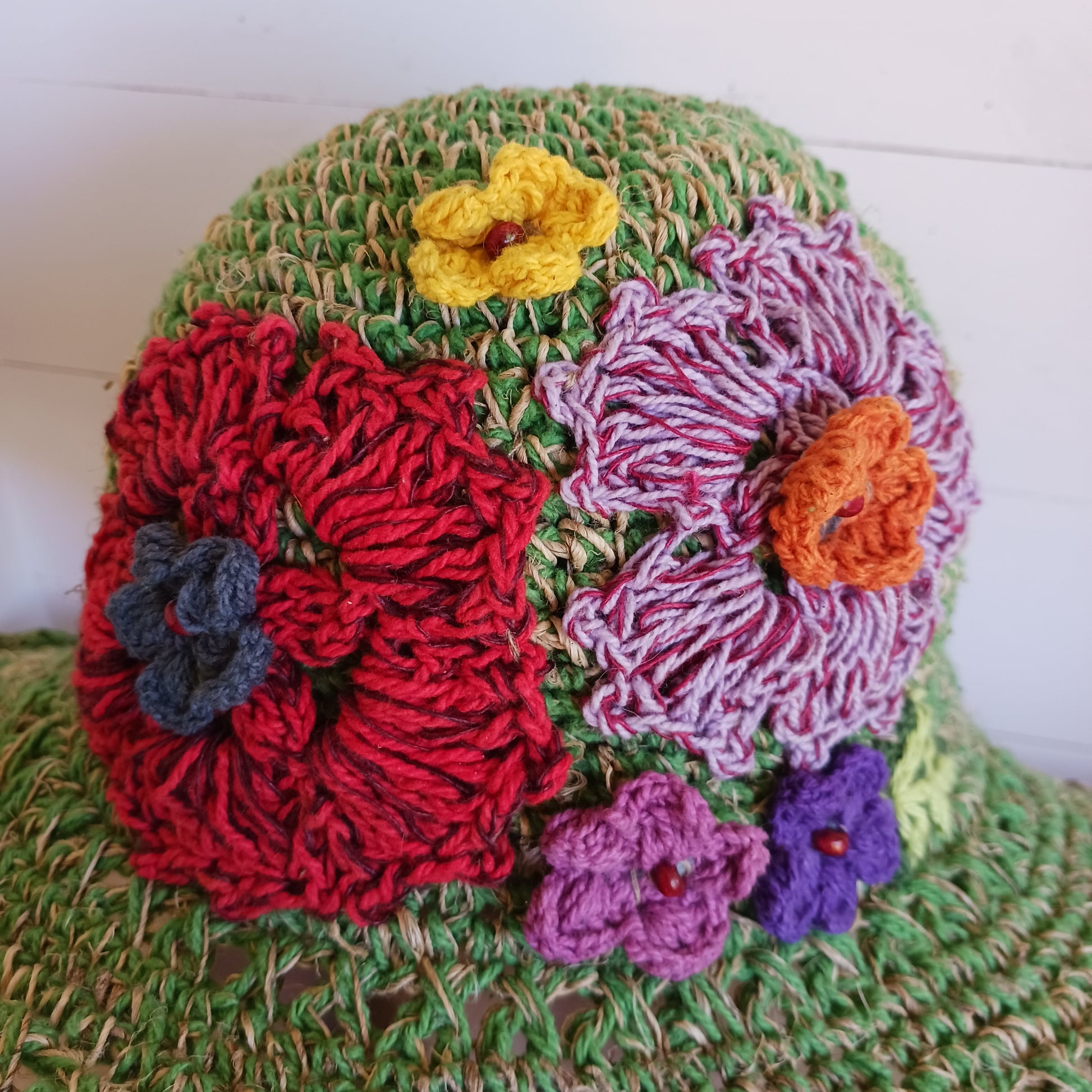 Hand-knitted Hemp & Cotton Boho Festival Hat with Rainbow band. A unique accessory that beautifully embodies the free-spirited essence of Bohemian style. Handcrafted with care, each of these hats is a harmonious blend of hemp and cotton, resulting in a distinctive piece that exudes both fashion and sustainability. They're ideal for music festivals, beach outings, or simply just to brighten up any outfit.
