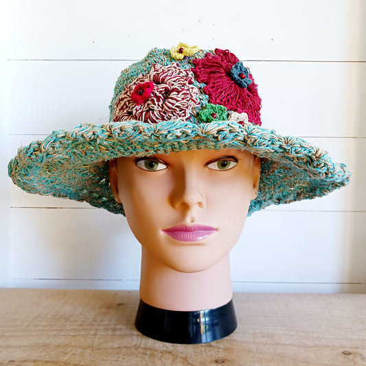 Handmade hemp & cotton boho festival hat with crochet flowers. A unique accessory that beautifully embodies the free-spirited essence of Bohemian style. Handcrafted with care and creativity, each of these hats is a harmonious blend of hemp and cotton, resulting in a distinctive piece that exudes both fashion and sustainability. They're ideal for music festivals, beach outings, or simply just to brighten up any outfit.