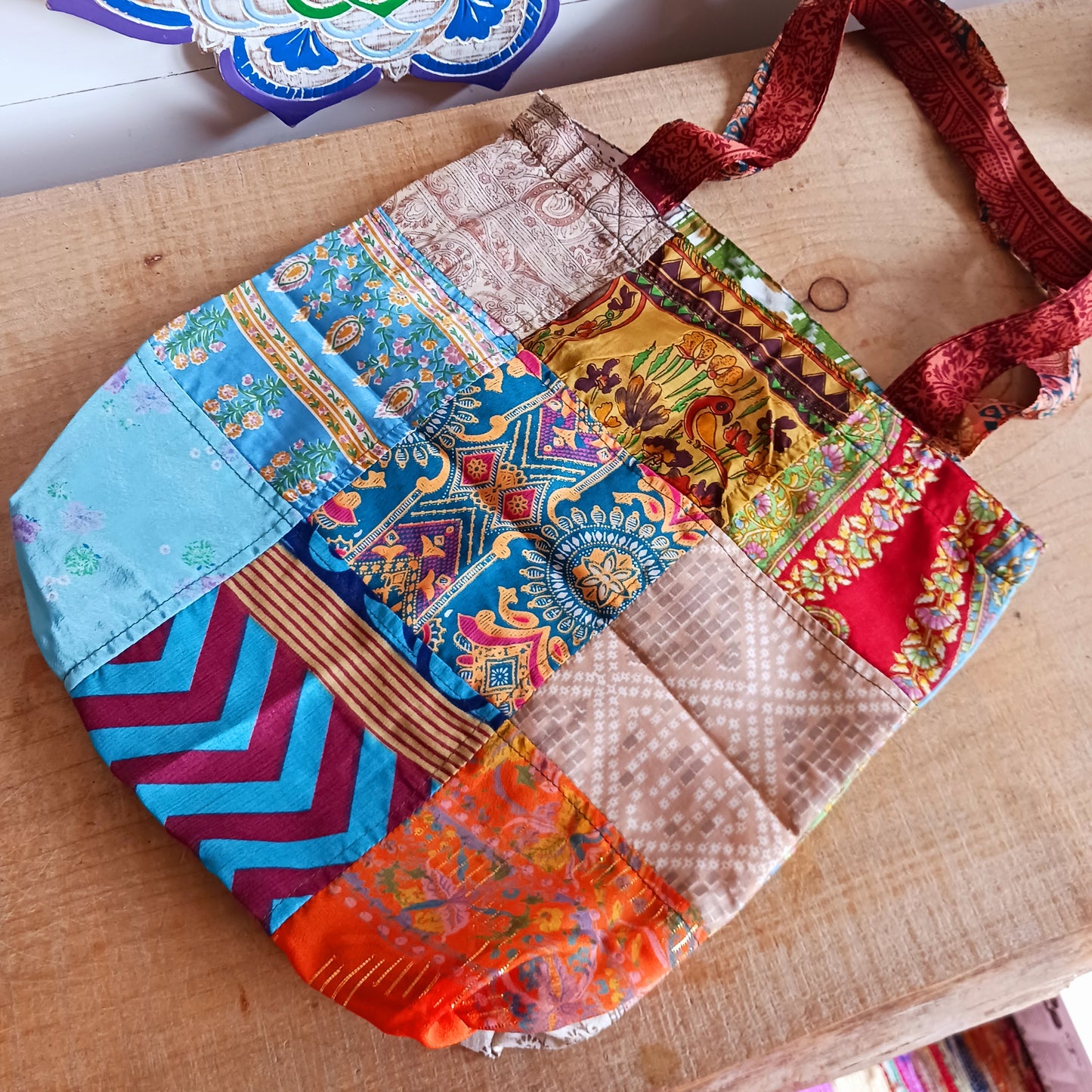 Shop like a pro! Pack this strong yet lightweight tote bag of colourful sari fabric with a black polyester lining. It's perfect for stuffing in your backpack, PC bag, cabin case, or glove box. The bag features a handy zippered external pocket for small bits and bobs like keys and coins.