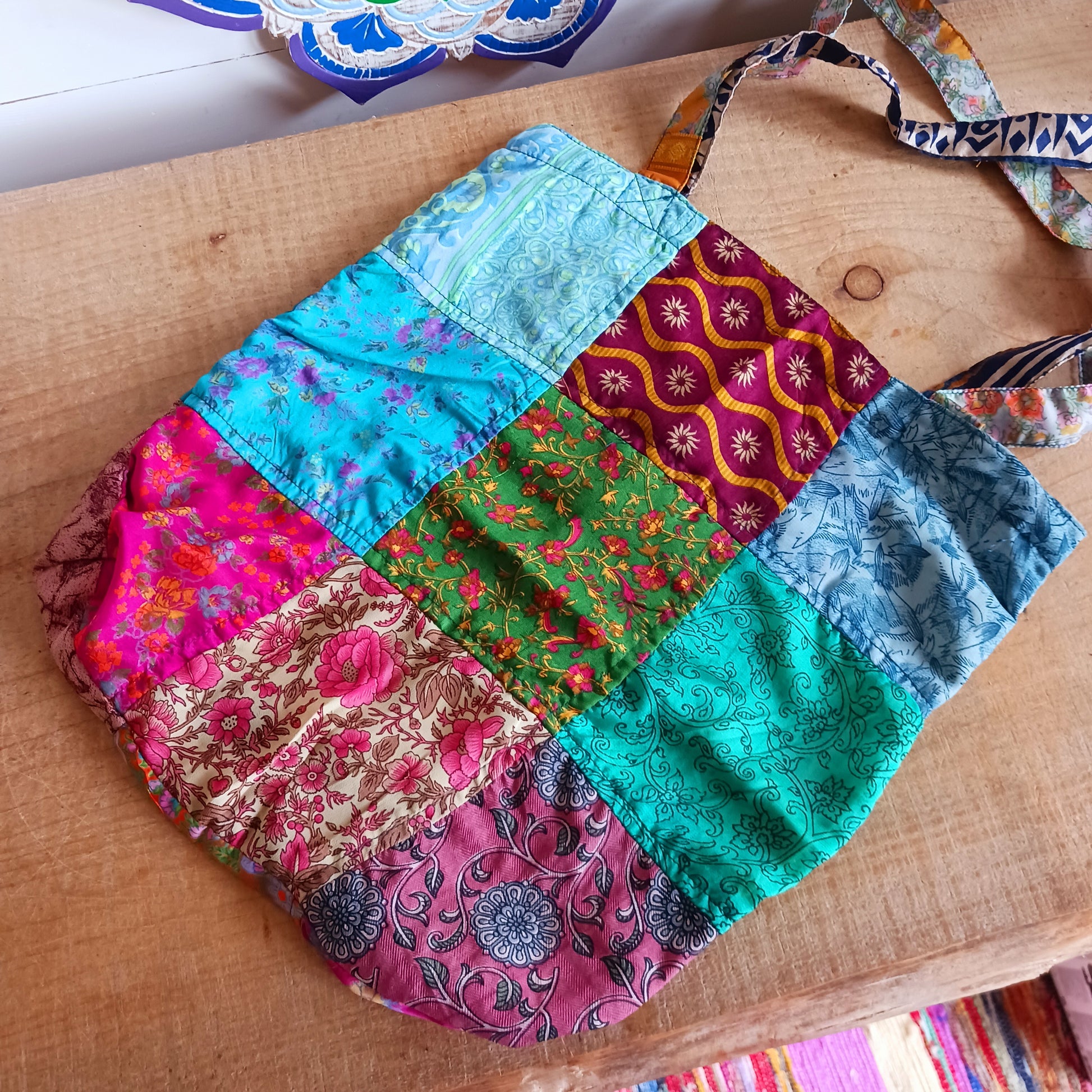 Shop like a pro! Pack this strong yet lightweight tote bag of colourful sari fabric with a black polyester lining. It's perfect for stuffing in your backpack, PC bag, cabin case, or glove box. The bag features a handy zippered external pocket for small bits and bobs like keys and coins.