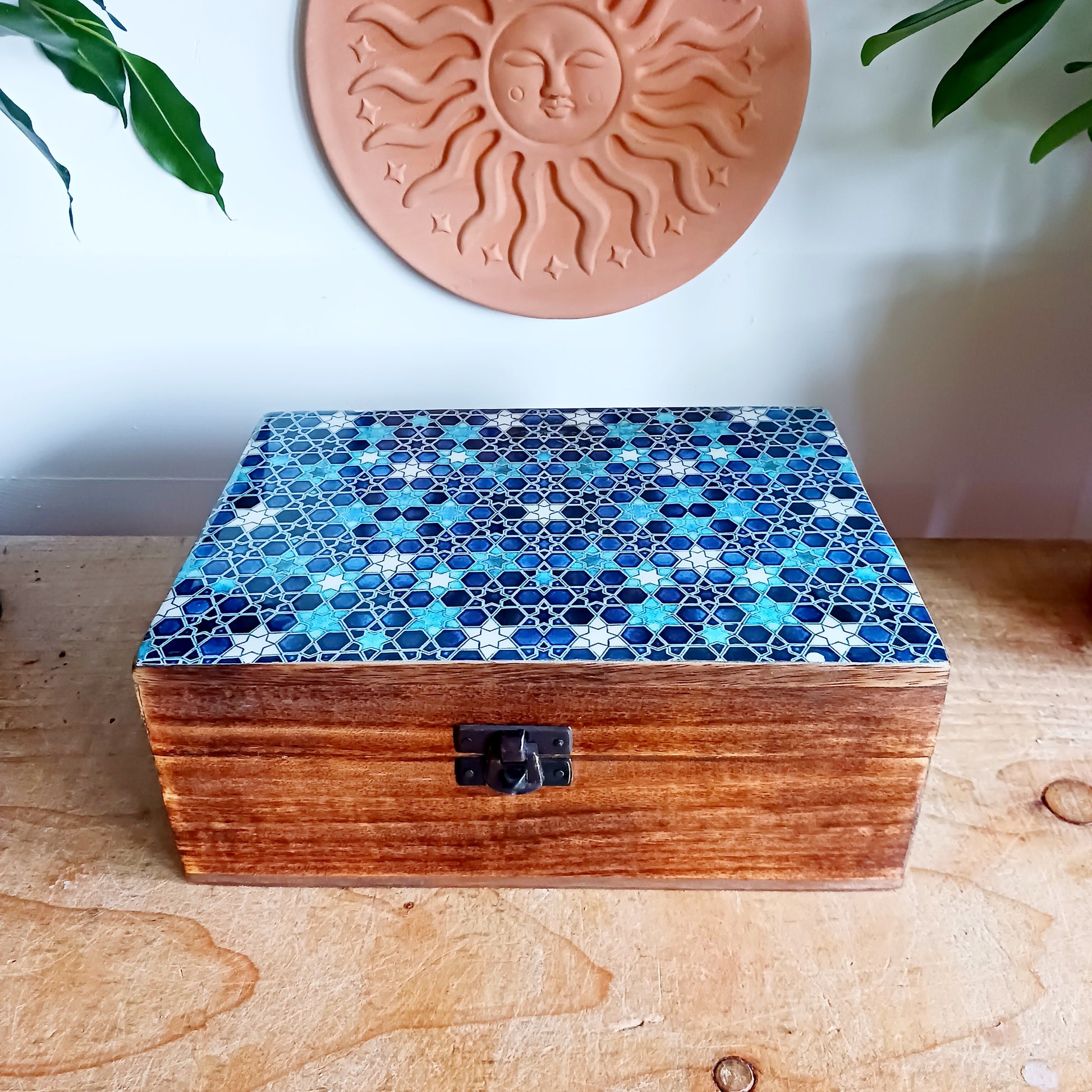 Add a touch of cultural elegance to your home with this Ceramic Glazed Wood Box. Expertly crafted, it combines the durability of solid wood with the glossy sophistication of glazed ceramic, making it both functional and decorative.