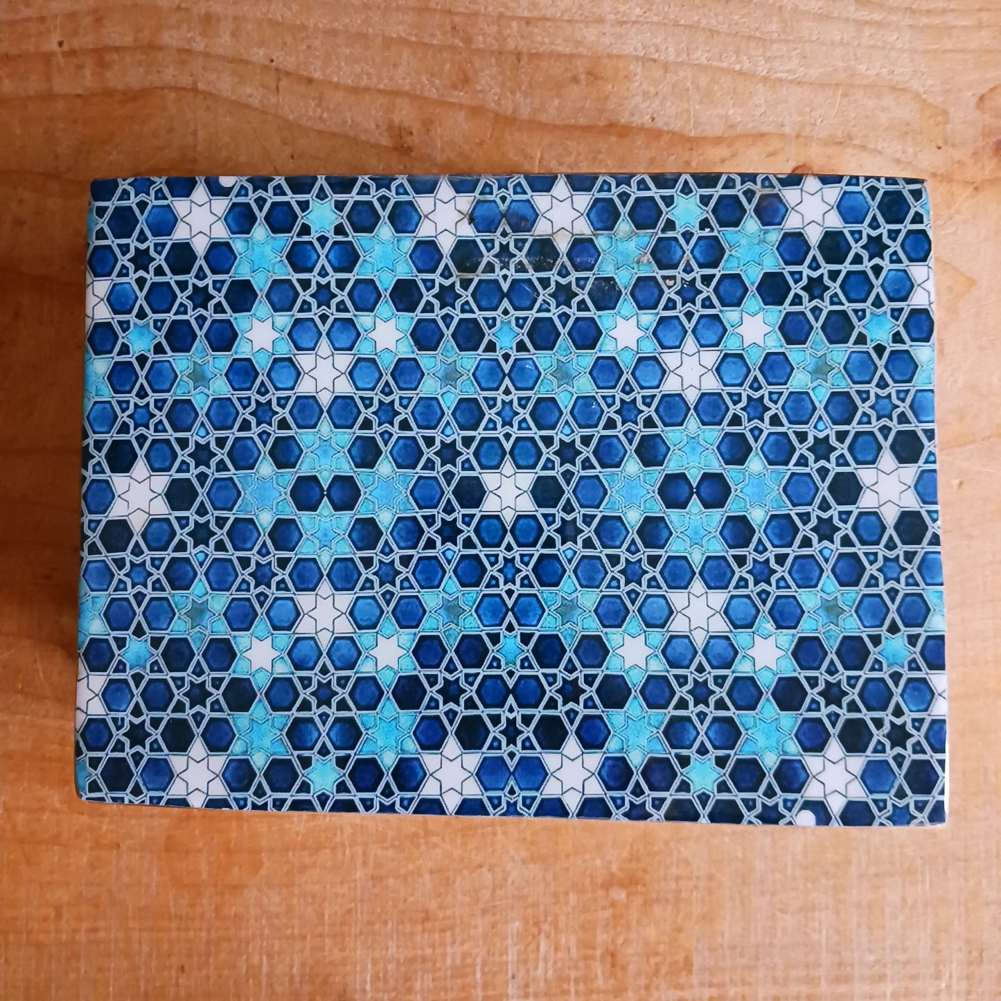 Add a touch of cultural elegance to your home with this Ceramic Glazed Wood Box. Expertly crafted, it combines the durability of solid wood with the glossy sophistication of glazed ceramic, making it both functional and decorative.