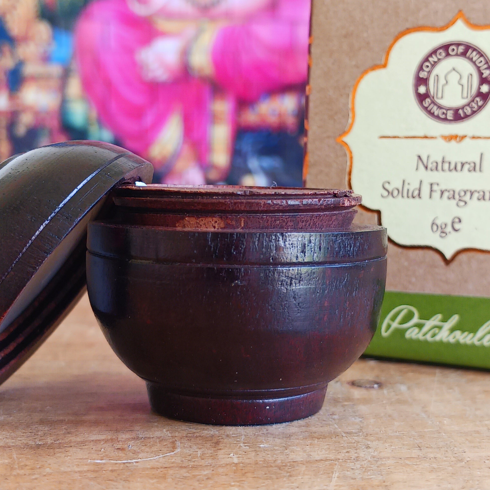 Experience the timeless beauty of jasmine with this luxurious Song of India Patchouli Fragrance Cream, beautifully housed in a handcrafted rosewood jar. Made by skilled artisans using carefully selected Indian rosewood bark, each container showcases unique natural grain patterns, colours, and veins, making every piece a one-of-a-kind collectible.