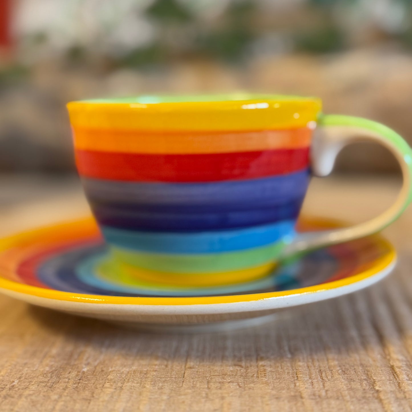 Enjoy your coffee in style with our handmade rainbow stripe ceramic cup & saucer. Fair-trade from Thailand, this vibrant, hand-painted set is dishwasher and microwave safe—perfect for brightening up any home.