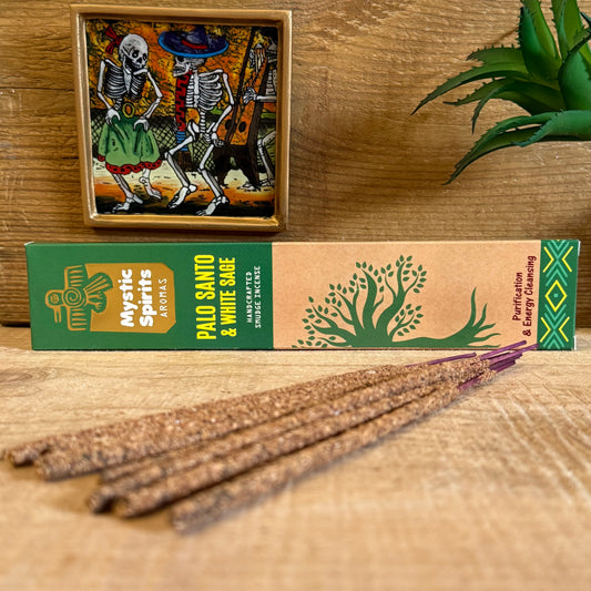 Cleanse your space and spirit with the sacred power of Mystic Spirits Palo Santo and White Sage Smudge Sticks. Hand-rolled in India, this incense is crafted from a traditional blend of fragrant gums, resins, wood powders, herbs, and spices, carrying both ancient wisdom and modern harmony.

Palo Santo, the holy wood of the shamans, offers a subtle, sweet and woody aroma with light notes of citrus and mint. Beloved for its ability to purify energy and uplift the spirit, it creates a calm and protective atmosp