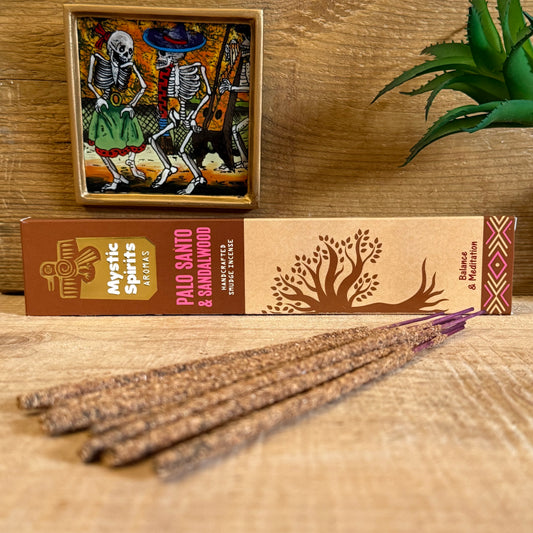 Breathe in the sacred union of Palo Santo and Sandalwood with this handcrafted incense from Mystic Spirits Aromas. Each stick is born of ancient tradition in India, where herbs, resins, and woods are blended with reverence to awaken the spirit and cleanse the soul.

Sandalwood, long cherished for its rich, oriental woody notes, has been a cornerstone of ritual and meditation for centuries. Its grounding fragrance steadies the mind, opening the way to clarity and inner peace. Palo Santo, the “holy wood” of t