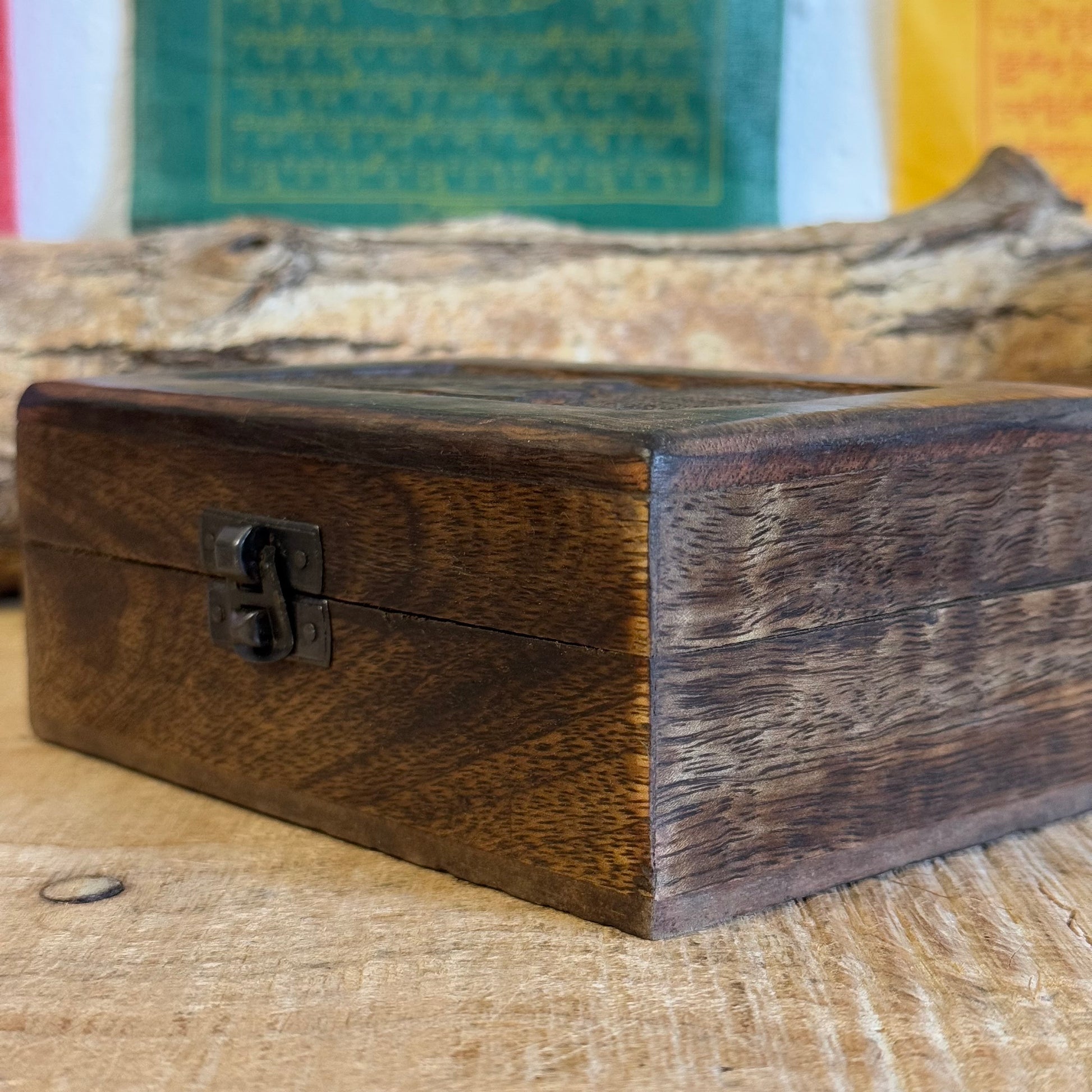 A lovely little hand carved Mango wood wooden box Hand carved in India It has a little brass fastening at the front, perfect for keeping your trinkets and keepsakes safe. Discover the beauty of hand carved craftsmanship from India with our Square Wooden Keepsake Box Om. Each box is carefully made from mango wood and features a charming brass fastening at the front. Keep your precious trinkets and keepsakes safe in this sturdy and stylish box.

Size is approx. 15 x 10 x 6 cm

Handmade in India