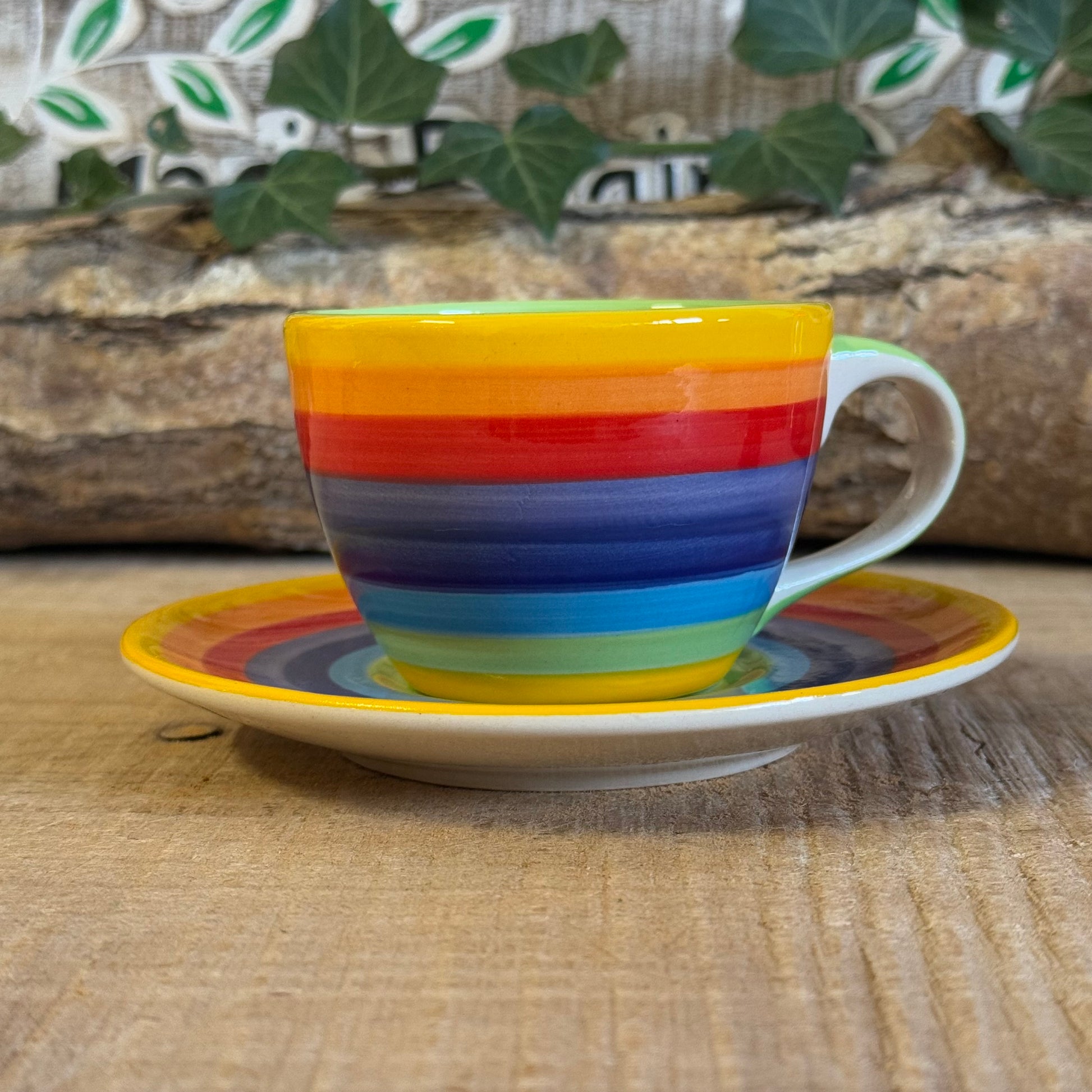 Enjoy your coffee in style with our handmade rainbow stripe ceramic cup & saucer. Fair-trade from Thailand, this vibrant, hand-painted set is dishwasher and microwave safe—perfect for brightening up any home.