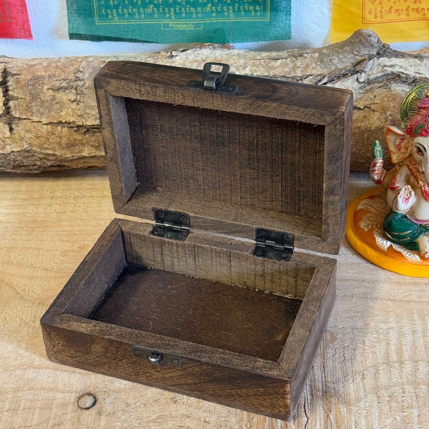 A lovely little hand carved Mango wood wooden box Hand carved in India It has a little brass fastening at the front, perfect for keeping your trinkets and keepsakes safe. Discover the beauty of hand carved craftsmanship from India with our Square Wooden Keepsake Box Om. Each box is carefully made from mango wood and features a charming brass fastening at the front. Keep your precious trinkets and keepsakes safe in this sturdy and stylish box.

Size is approx. 15 x 10 x 6 cm

Handmade in India