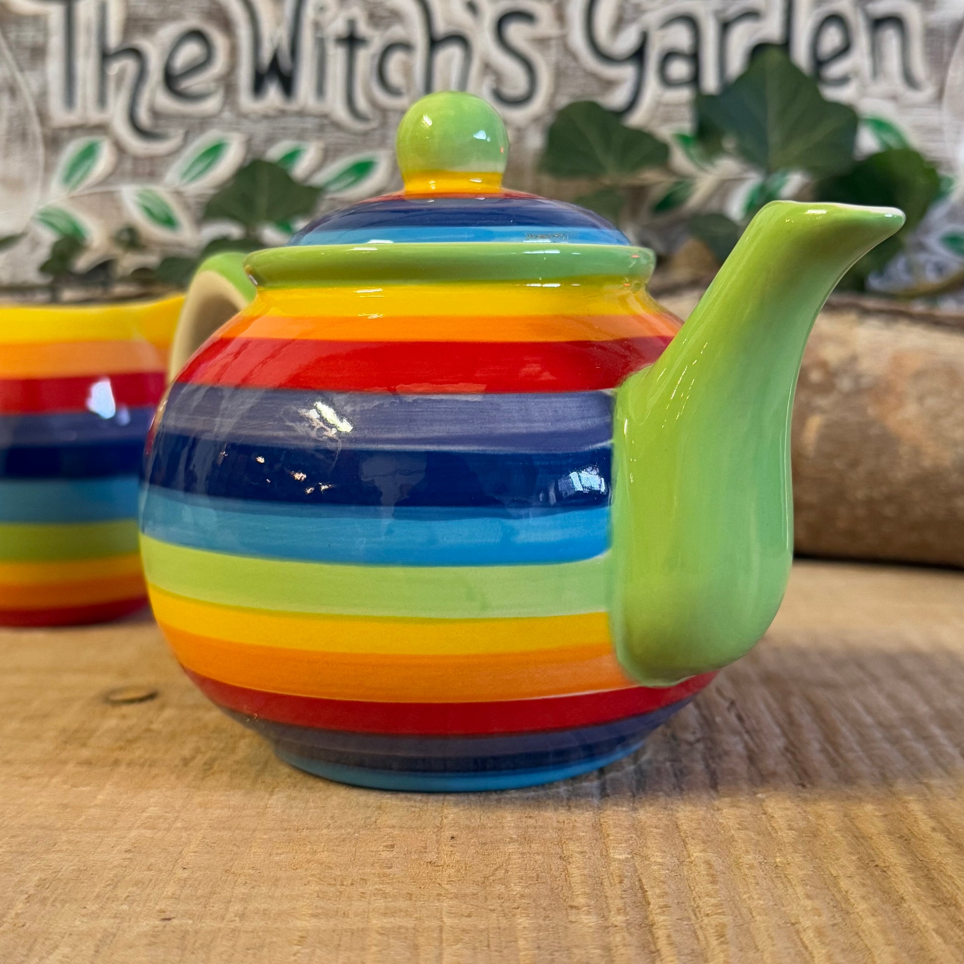 Discover our handcrafted 2-cup ceramic teapot from Thailand, featuring a vibrant rainbow design. Eco-friendly, fair-trade, dishwasher & microwave safe—perfect for elevating your tea rituals with style and sustainability.