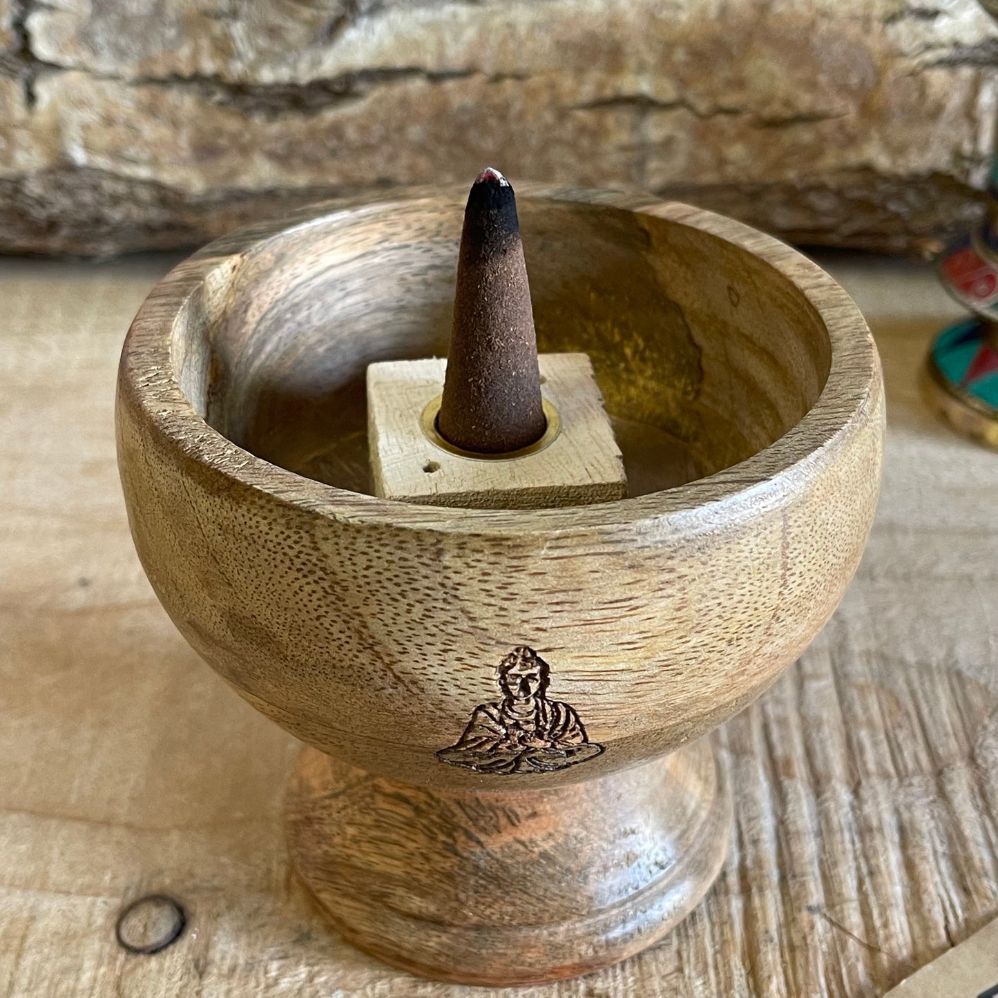 This incense holder boasts a compact and detailed design, with dimensions of 11 cm across and a 10 cm height. Its innovative design allows for the use of both incense sticks and cones, catering to a variety of incense rituals. The bowl-shaped holder showcases a delicately etched Buddha symbol on its interior, serving as a focal point and elevating its spiritual atmosphere. The meticulous engraving adds a touch of serenity, promoting a reflective and meditative atmosphere to any space. Perfect for altar sett