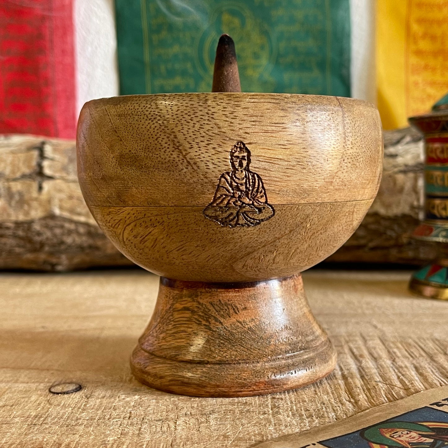 This incense holder boasts a compact and detailed design, with dimensions of 11 cm across and a 10 cm height. Its innovative design allows for the use of both incense sticks and cones, catering to a variety of incense rituals. The bowl-shaped holder showcases a delicately etched Buddha symbol on its interior, serving as a focal point and elevating its spiritual atmosphere. The meticulous engraving adds a touch of serenity, promoting a reflective and meditative atmosphere to any space. Perfect for altar sett