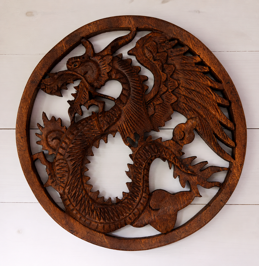 Bring strength, wisdom and timeless craftsmanship into your home with this hand carved Wooden Dragon Plaque. Expertly crafted in Indonesia from sustainably sourced wood, each plaque features an intricate dragon design inspired by ancient folklore and cultural traditions. Dragons have long symbolised protection, courage and guardianship across many cultures, making this striking wall hanging a meaningful addition to any living space. Every piece is individually carved by skilled artisans under Fair Trade con