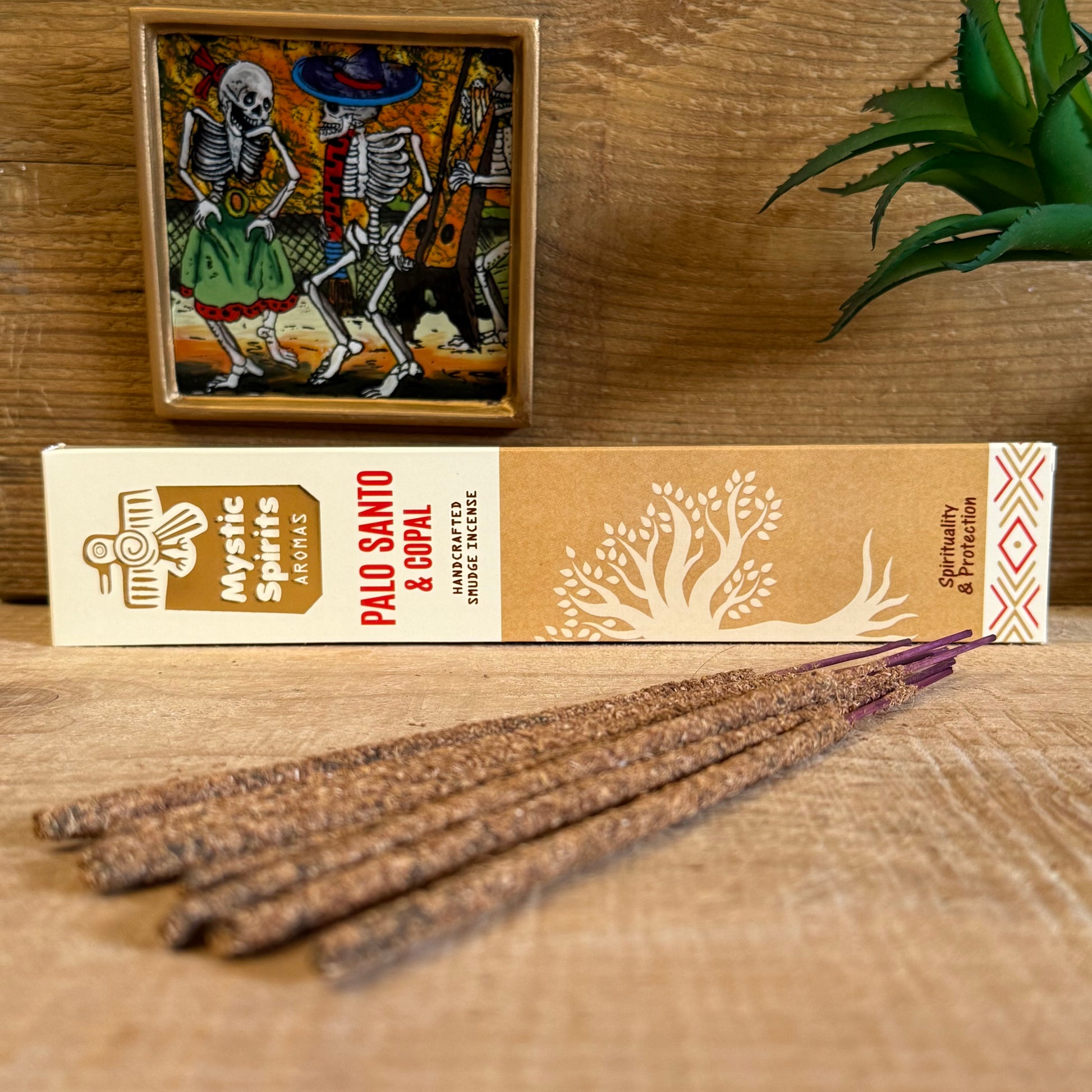 Step into the sacred fires of purification with Mystic Spirits Palo Santo and Copal Smudge Sticks. Hand-rolled in India from a sacred blend of fragrant gums, resins, wood powders, herbs, and spices, these incense sticks carry the wisdom of the ancients.

Palo Santo, the revered “holy wood,” offers a gentle fragrance that is woody, subtly sweet, with whispers of citrus and mint. It is known among shamans for clearing negative energies, uplifting the spirit, and creating sacred space.