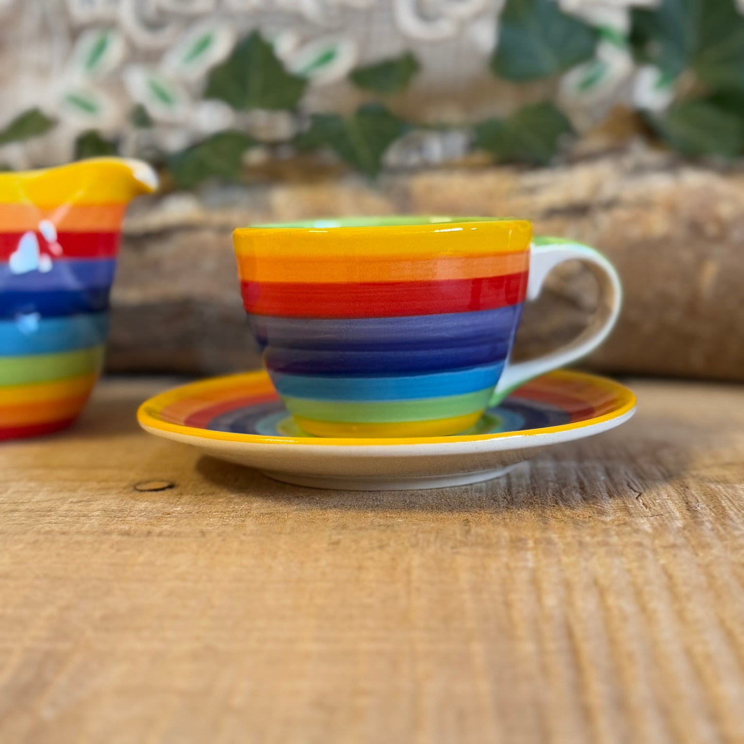 Enjoy your coffee in style with our handmade rainbow stripe ceramic cup & saucer. Fair-trade from Thailand, this vibrant, hand-painted set is dishwasher and microwave safe—perfect for brightening up any home.