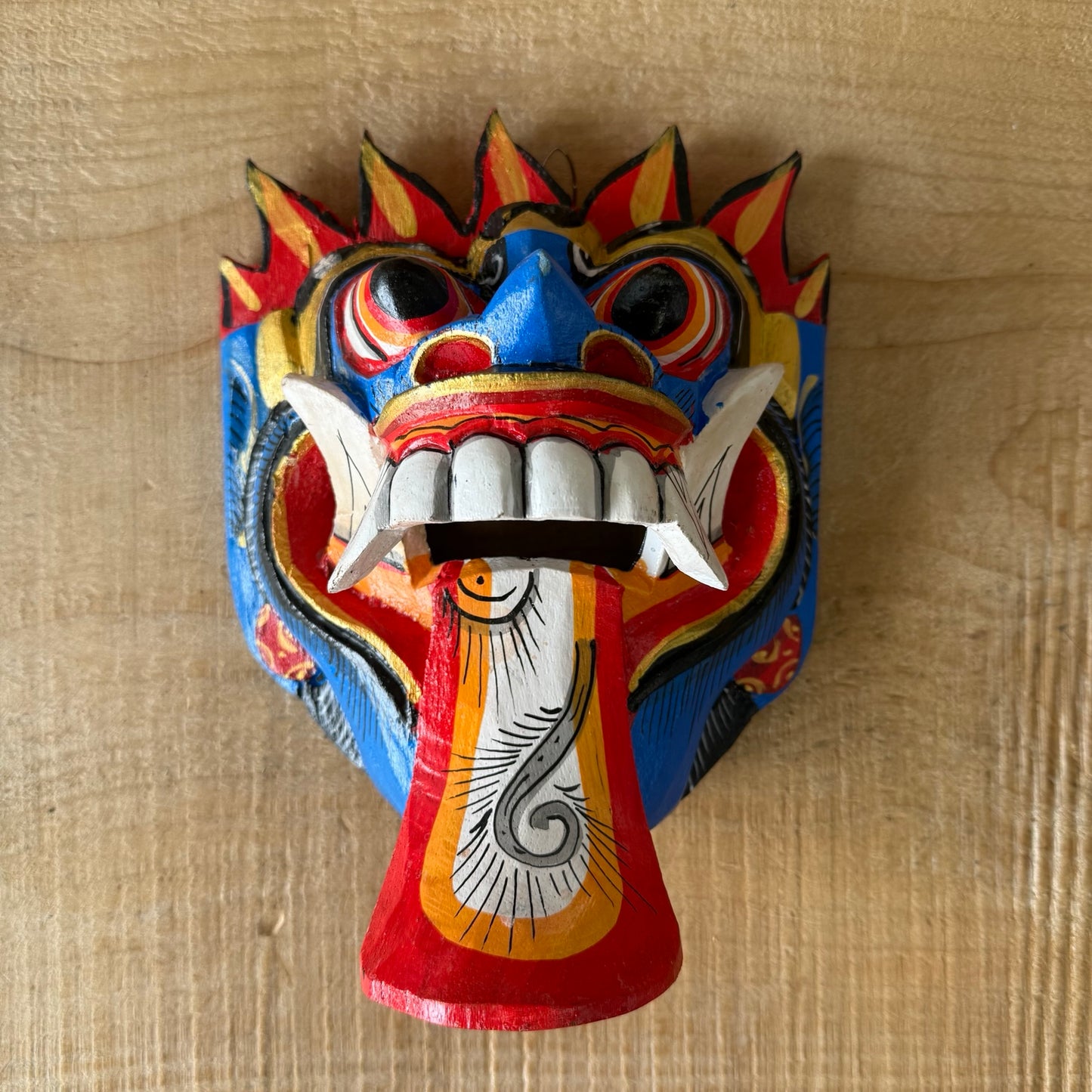 Hand carved Balinese Rangda Mask wall hanging featuring vibrant blue, red and gold colours, traditional tribal design and authentic Indonesian craftsmanship.