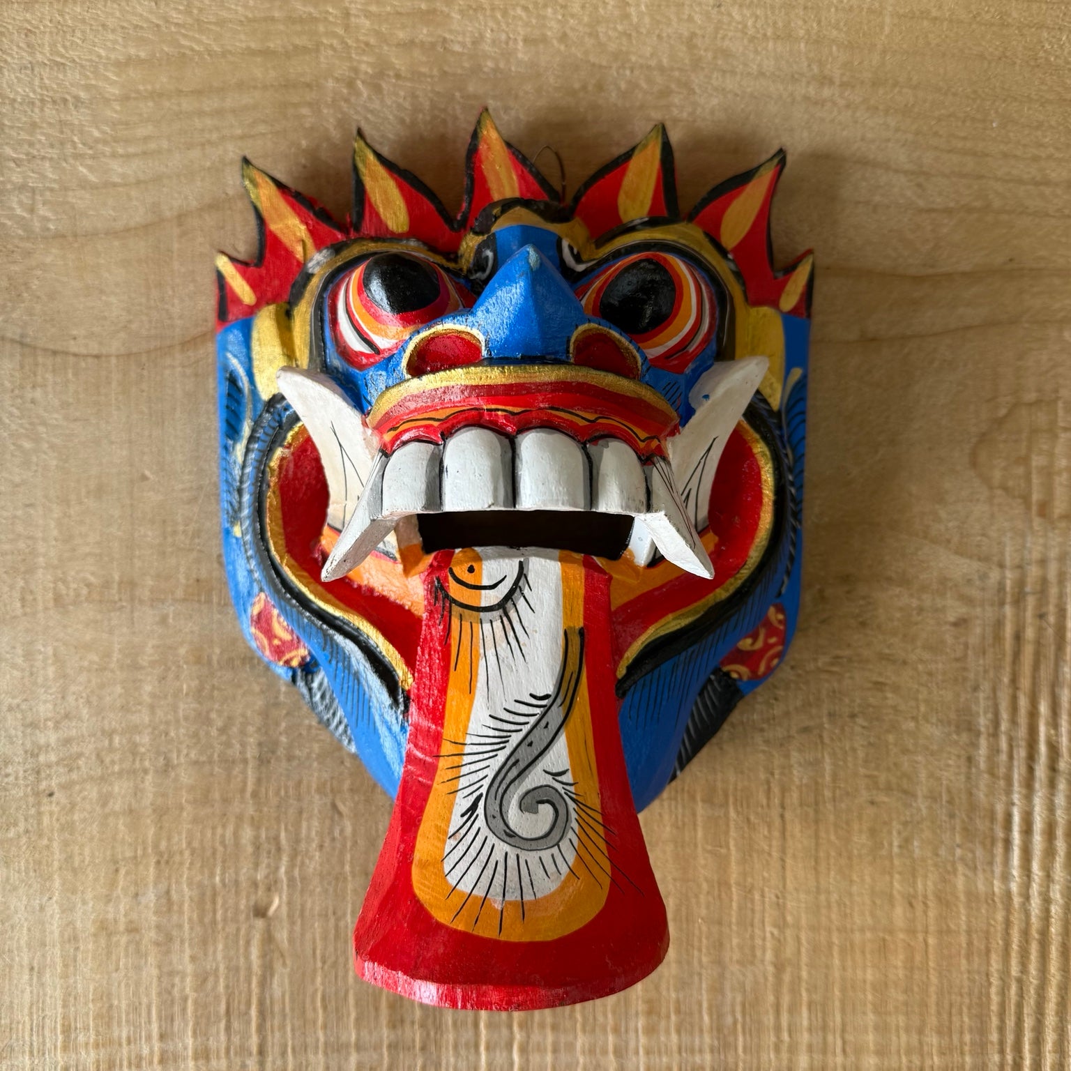 Hand carved Balinese Rangda Mask wall hanging featuring vibrant blue, red and gold colours, traditional tribal design and authentic Indonesian craftsmanship.