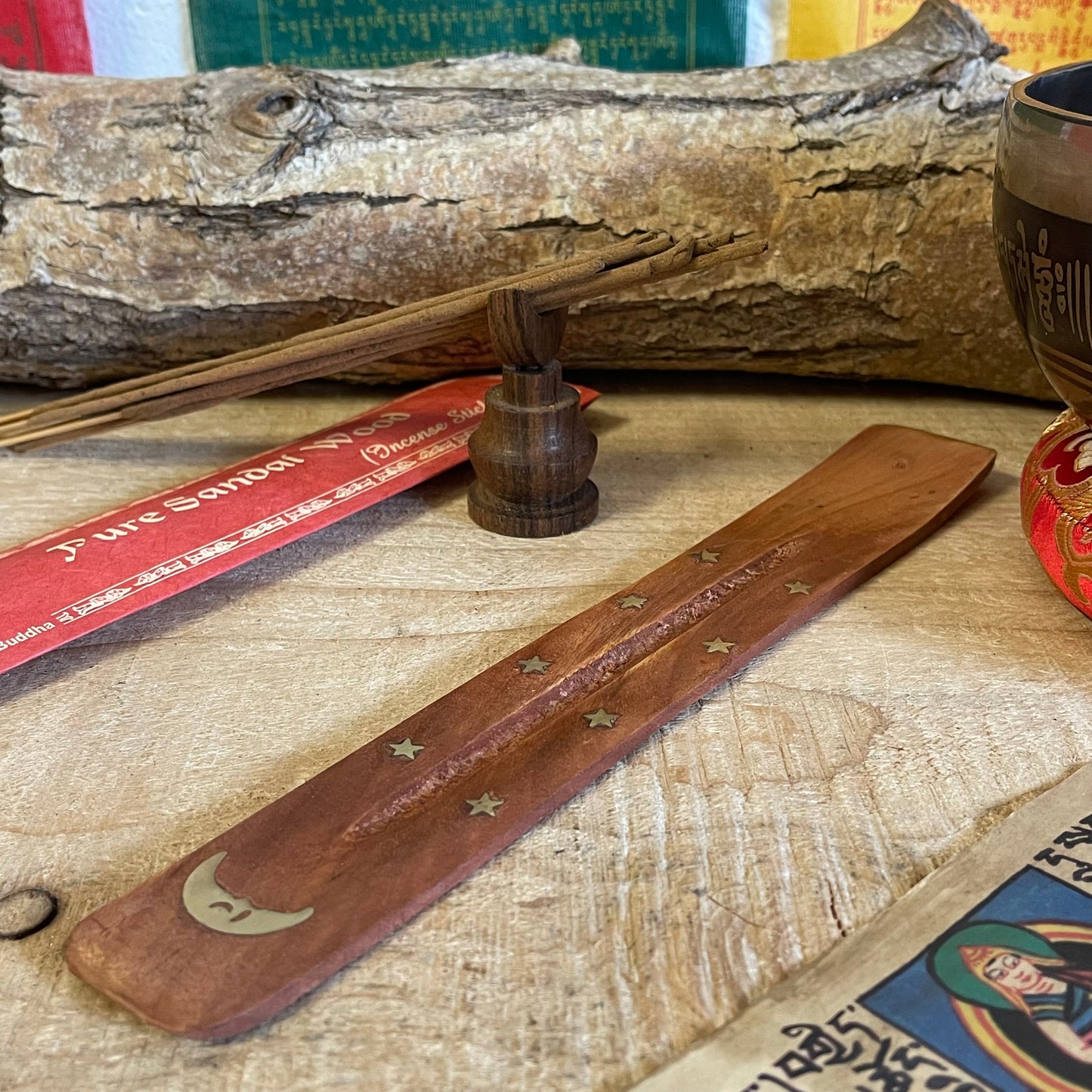 Introducing our most popular incense holder—a beautifully crafted shoe horn-style ash catcher made from high-quality mango wood. This unique piece is perfect for stick incense and features delightful inlays of stars and a whimsical Banana Moon.