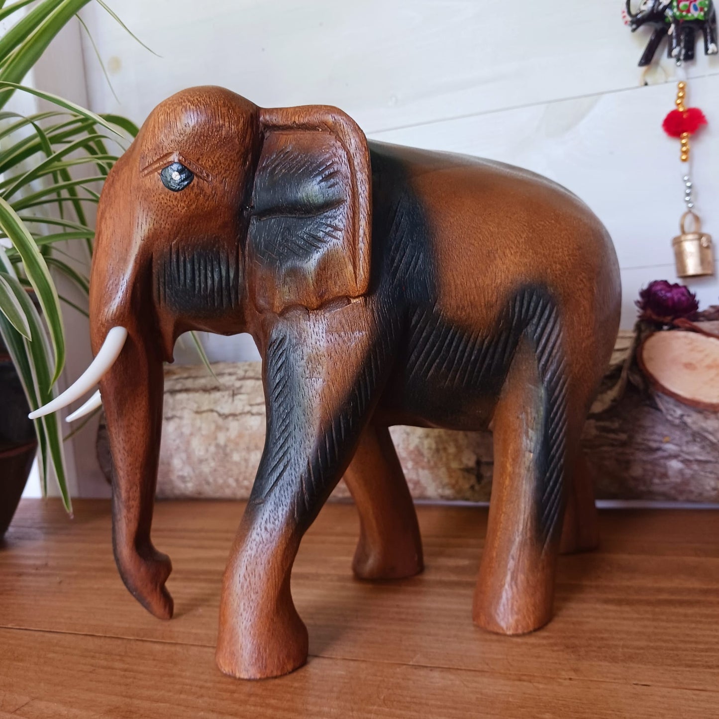 This beautiful large wooden elephant ornament has been hand carved from acacia wood. This elephant will bring a cultural touch to any room in your home.