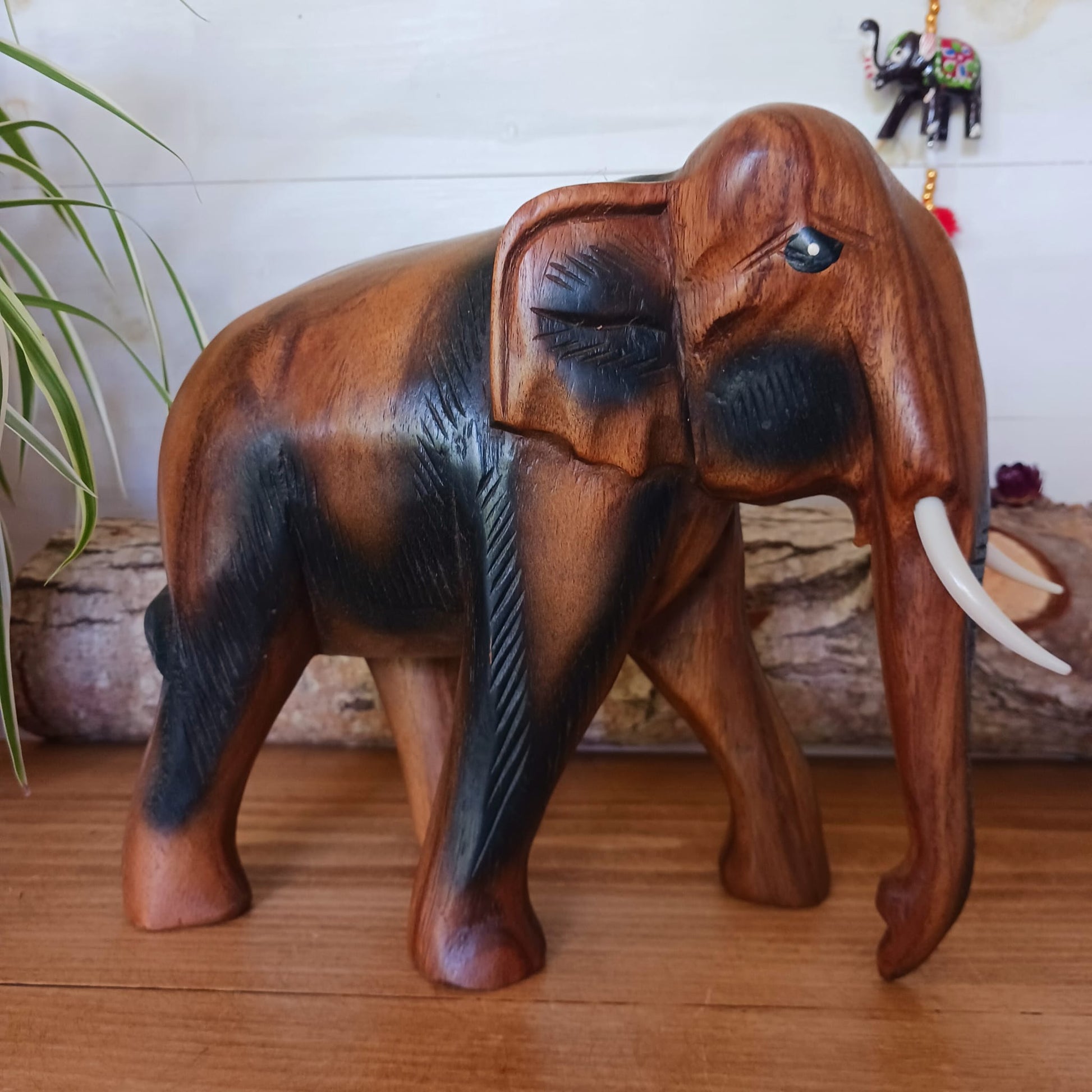 This beautiful large wooden elephant ornament has been hand carved from acacia wood. This elephant will bring a cultural touch to any room in your home.